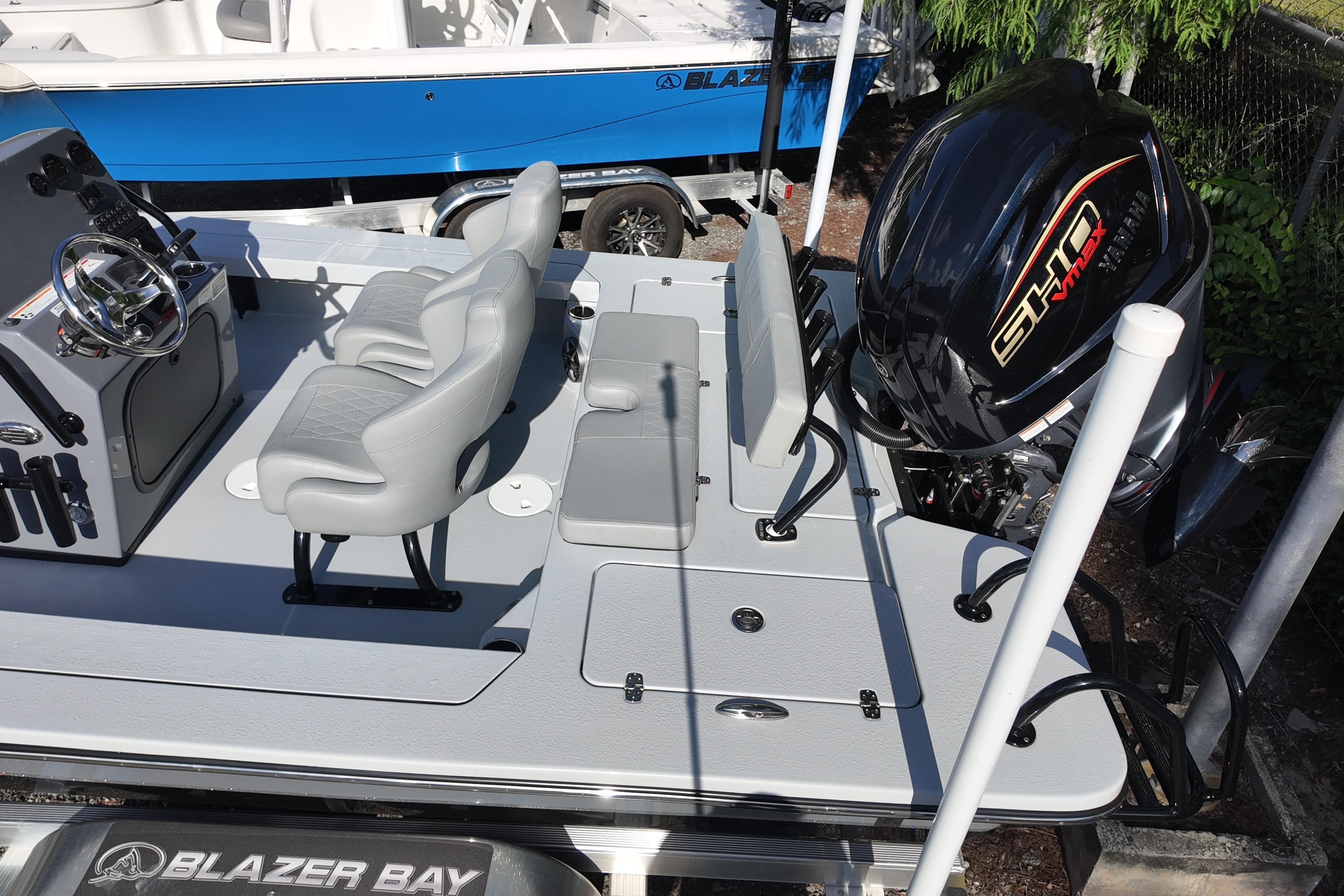 2026 Blazer Bay 675 Ultimate Bay boat interior with seating and motor.