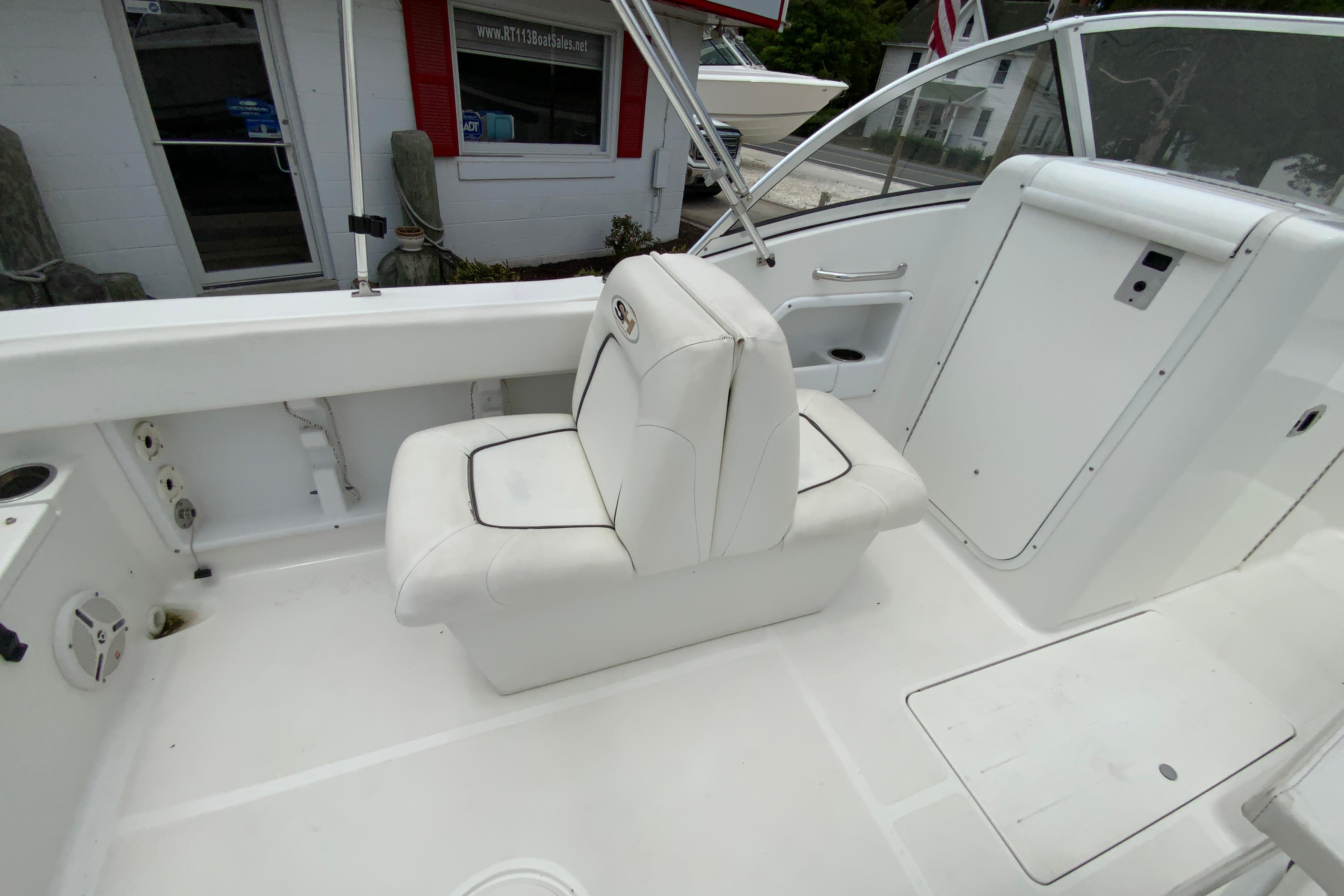 2014 Sea Hunt Escape 211 LE boat interior with white seating and storage compartments.