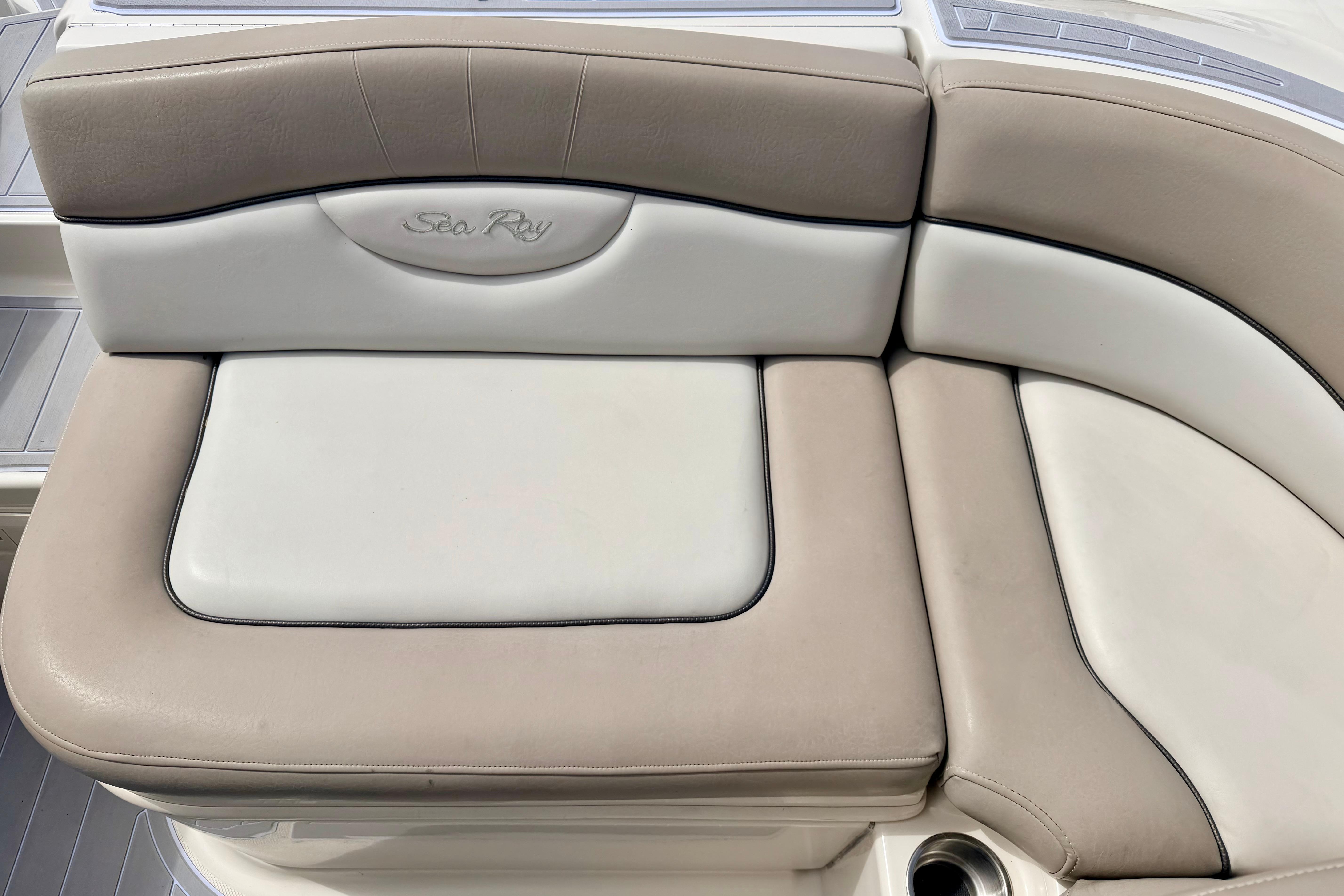 2003 Sea Ray 200 Sundeck boat seating, featuring beige and white cushioned upholstery.
