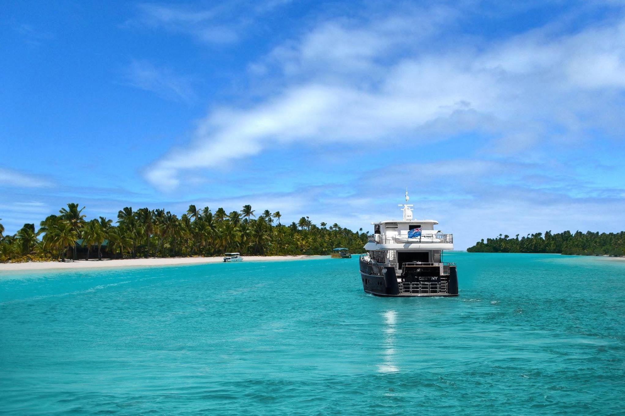 Fifth Ocean Yachts 24m Explorer Yacht cruising in turquoise waters near a tropical island, 2014.