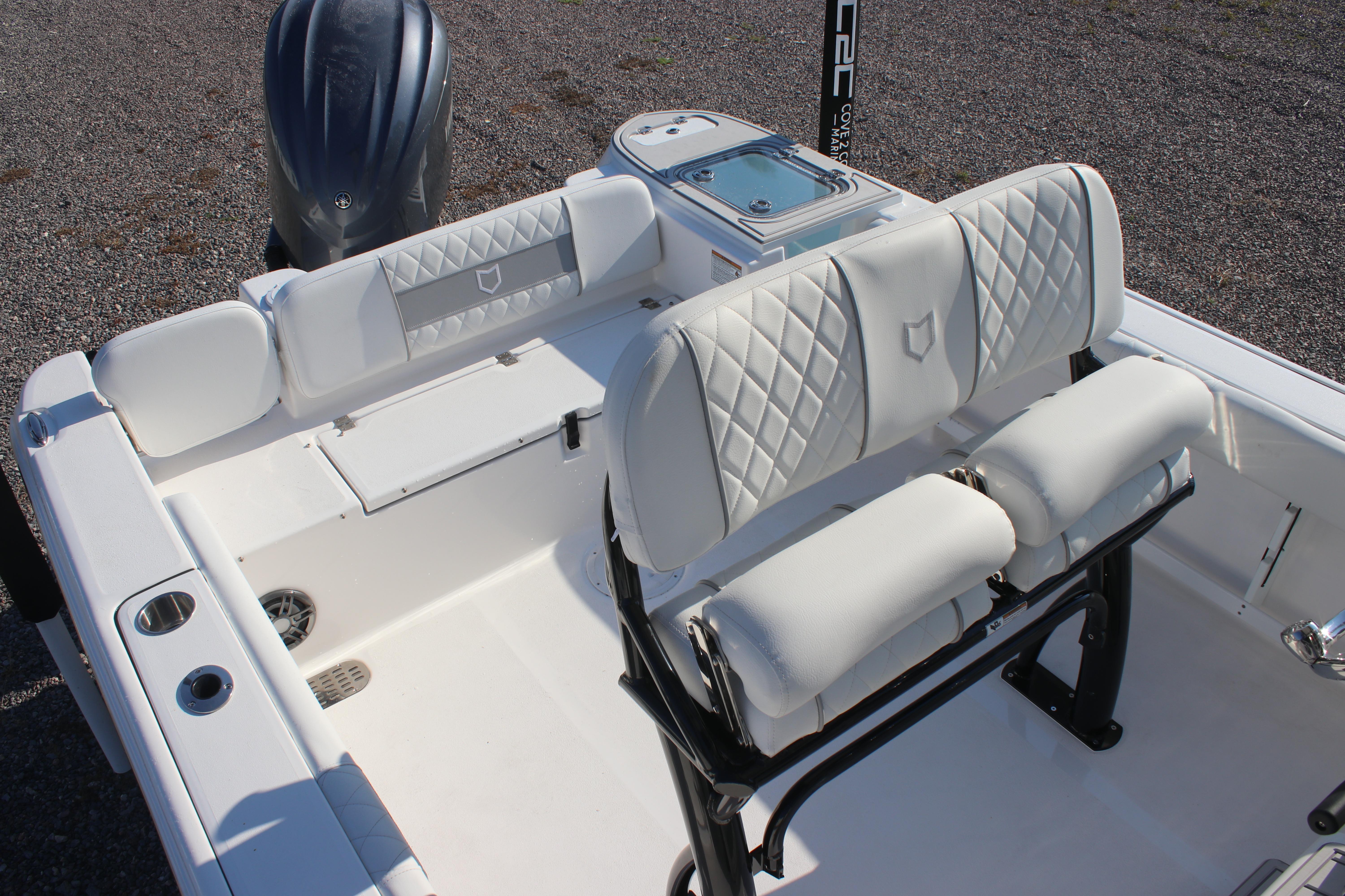 2026 Sea Fox 248 Commander boat interior with white cushioned seating and sleek design.