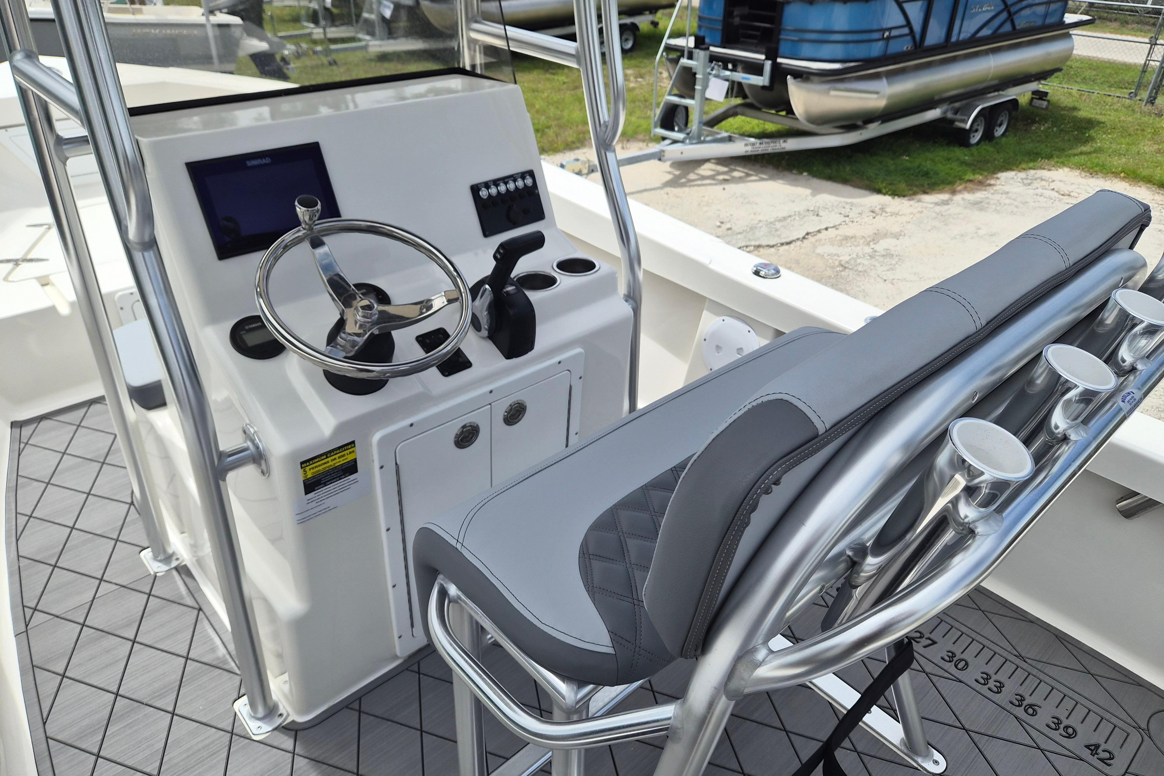 2026 Defiance Catalina 190 boat cockpit with steering wheel and seating.