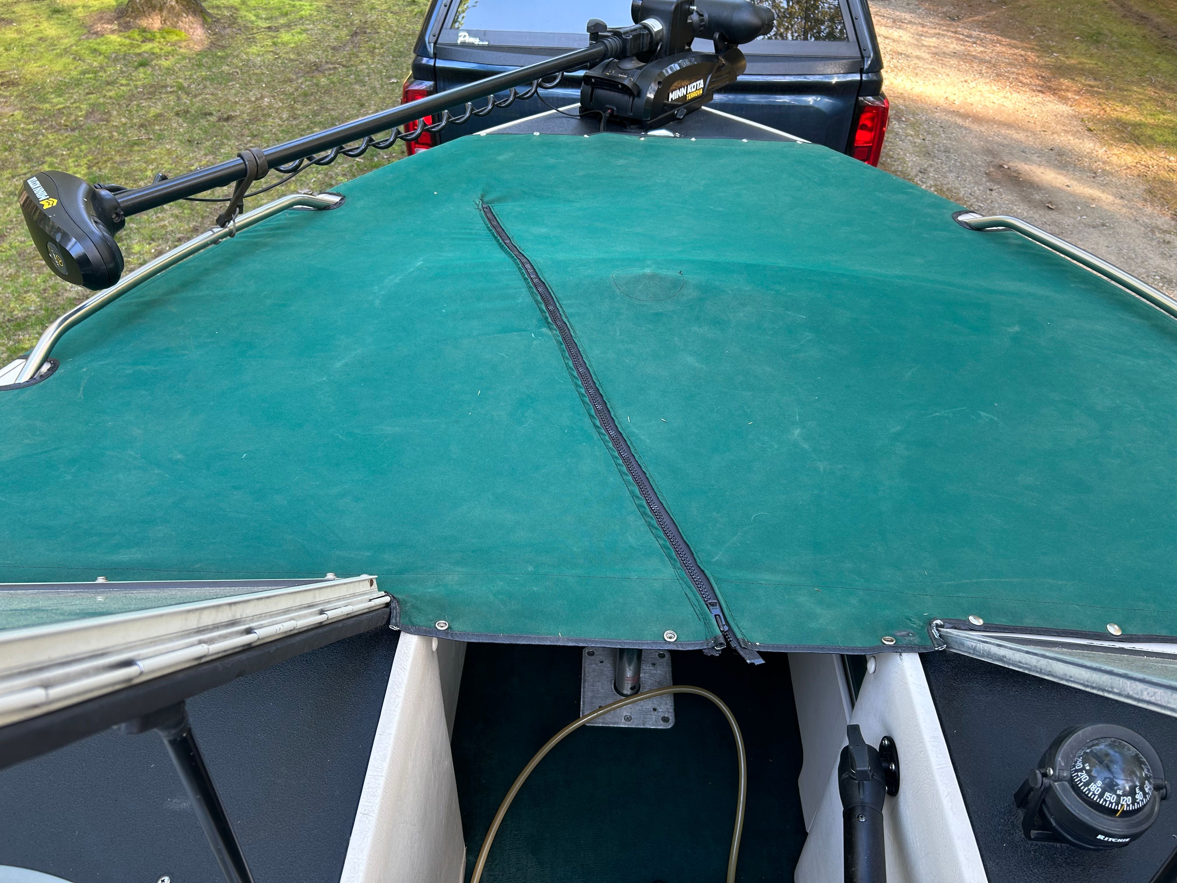 1997 Crestliner 2050 Sportfish with green boat cover and Minn Kota motor.