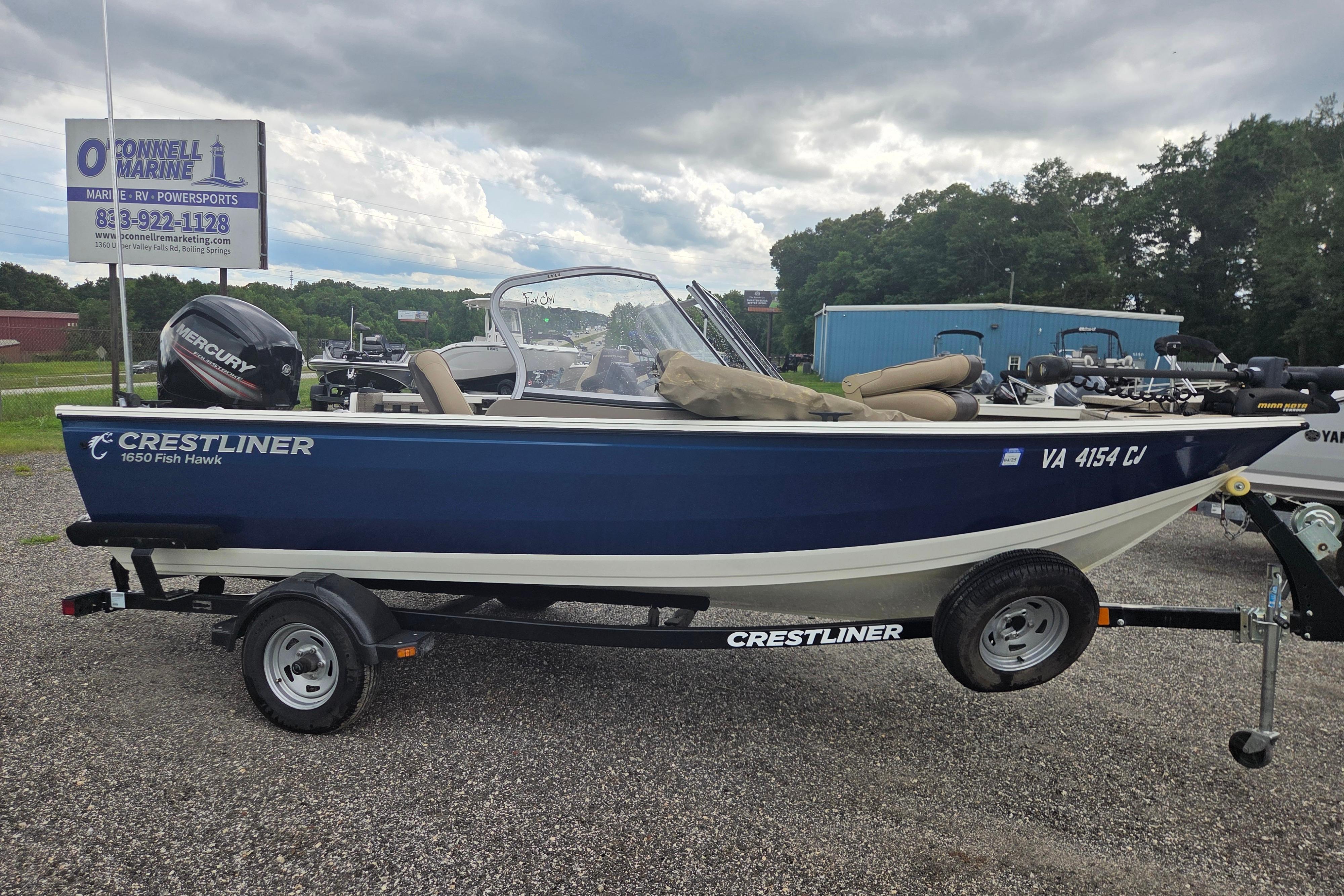 2016 Crestliner 1650 Fish Hawk SC boat on trailer, displayed outdoors.