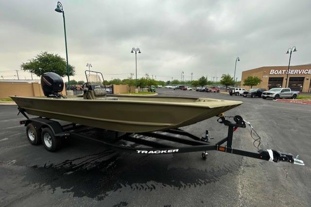2026 Tracker Grizzly 2072 CC boat on trailer in parking lot, overcast sky.