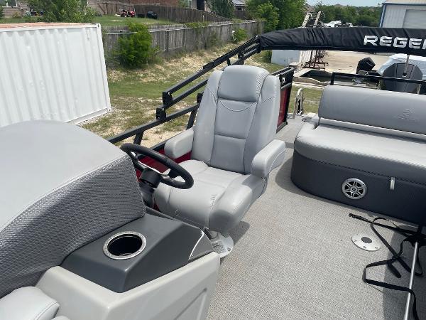 2023 Regency 250DL3 pontoon boat interior with gray seating and steering console.