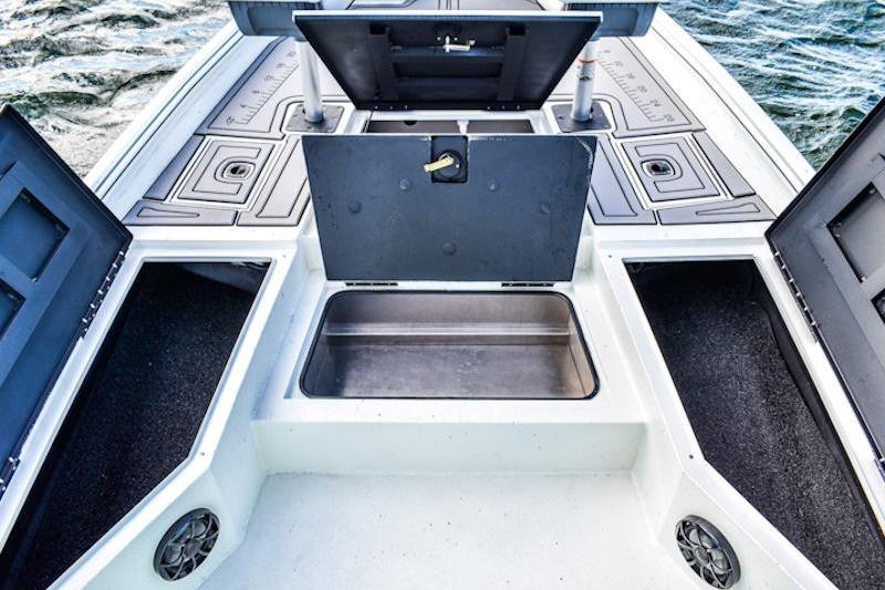 2026 Excel 230 Bay Pro Elite boat with open storage compartments on deck.