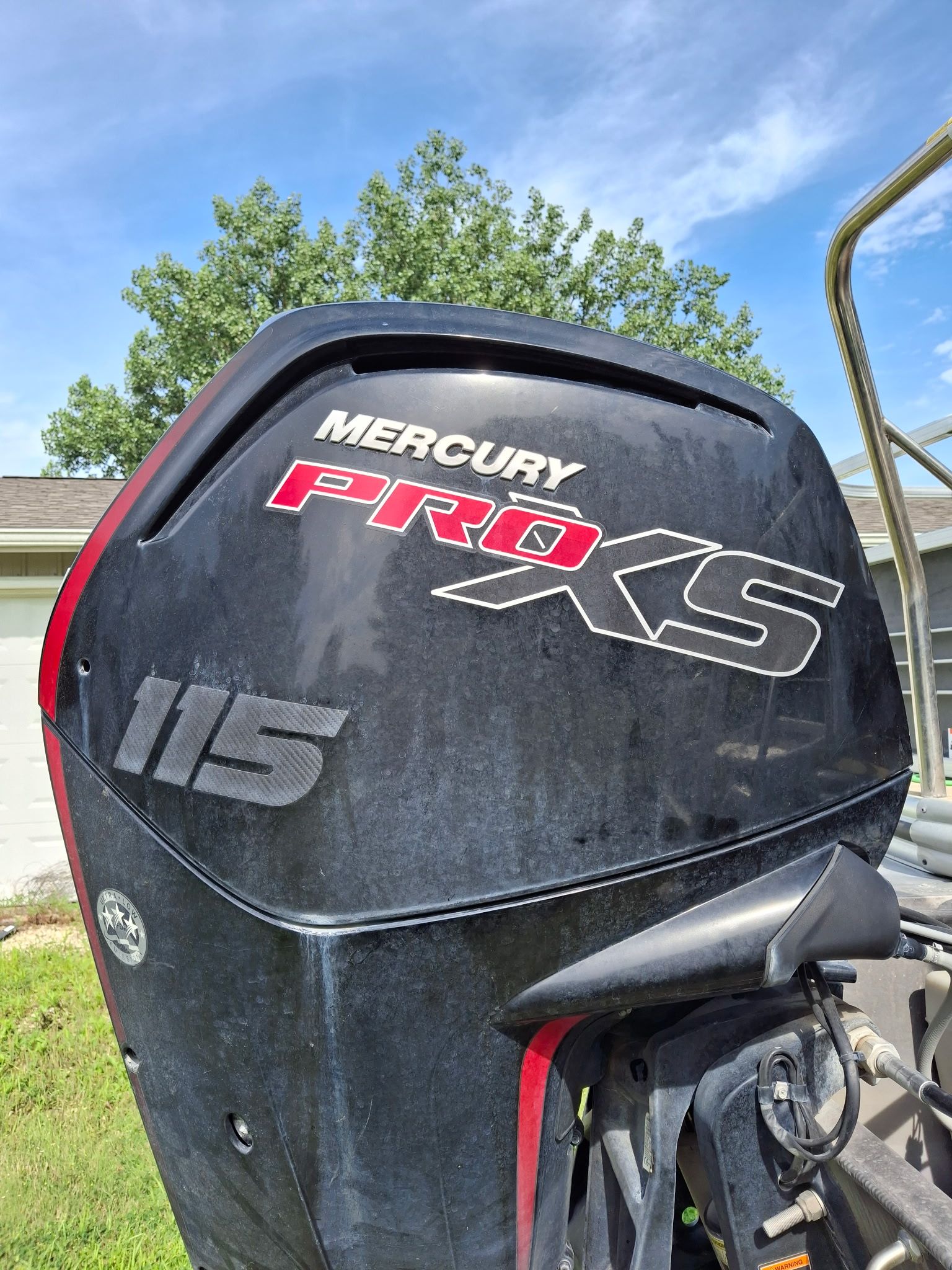 A Mercury Pro XS 115 outboard motor on a boat.