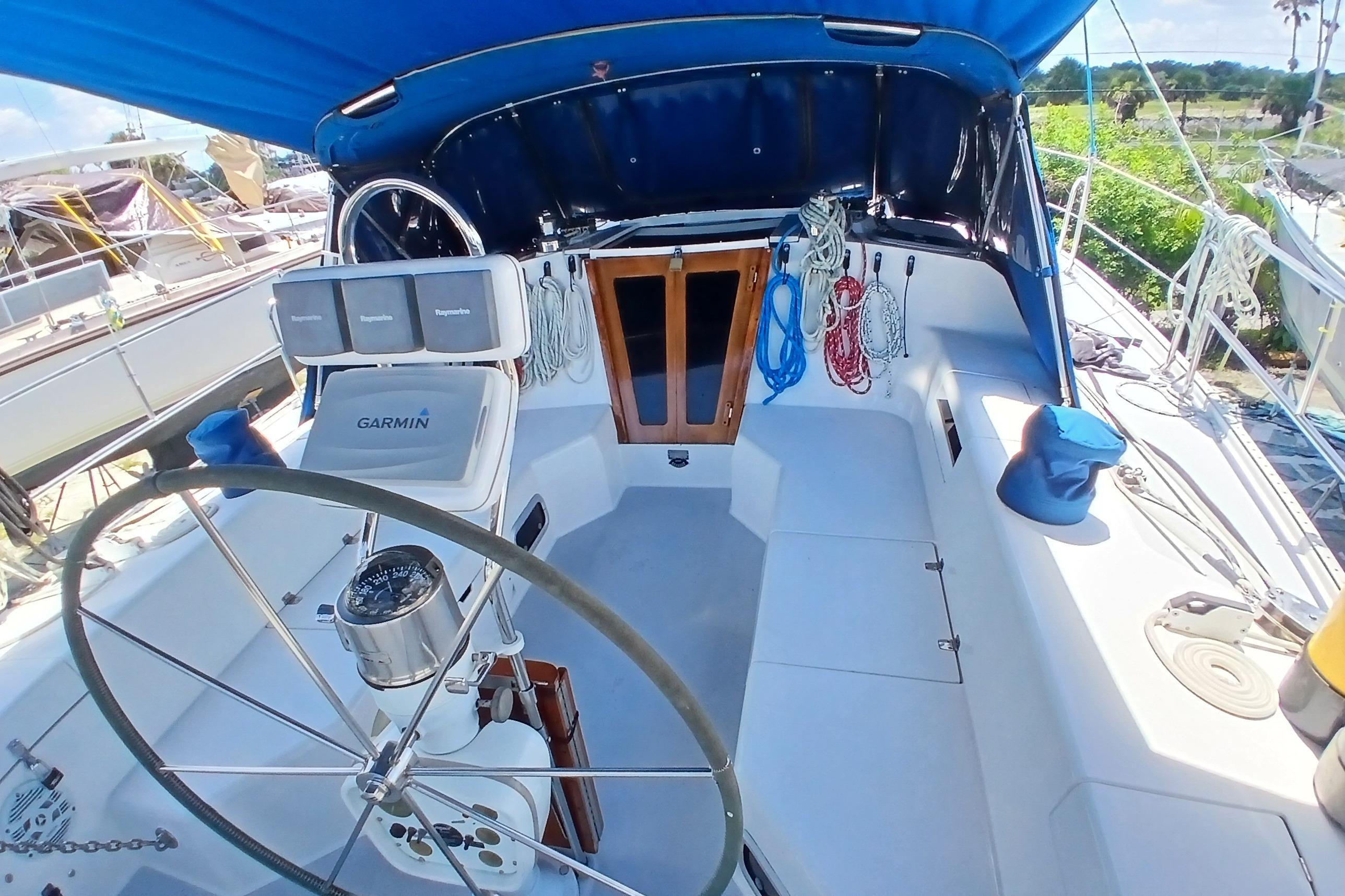 Cockpit of a 1995 Catalina 42 MkII sailboat with steering wheel and navigation equipment.