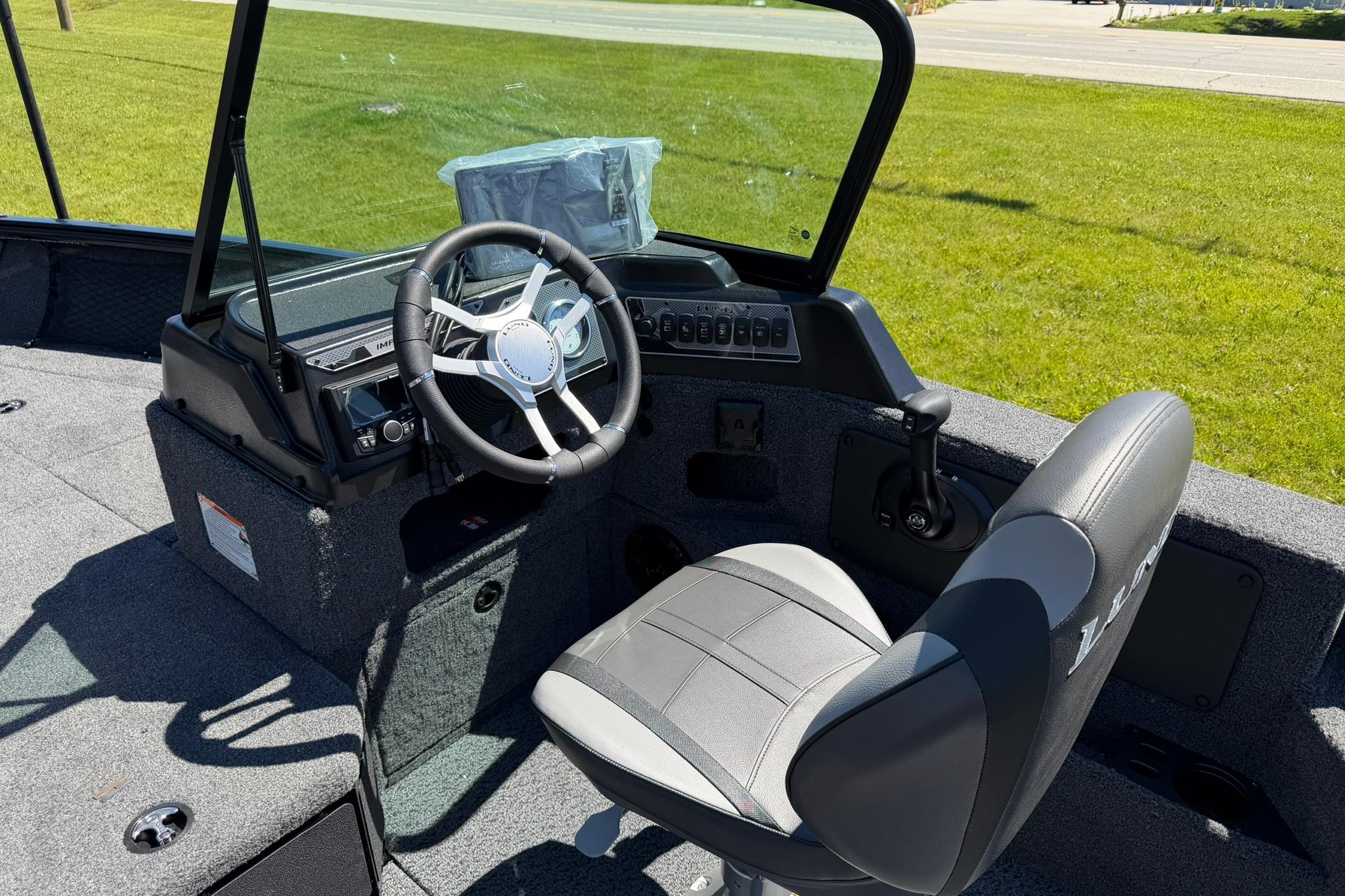 2027 Lund 1775 Impact XS Sport boat interior with steering wheel and seat.