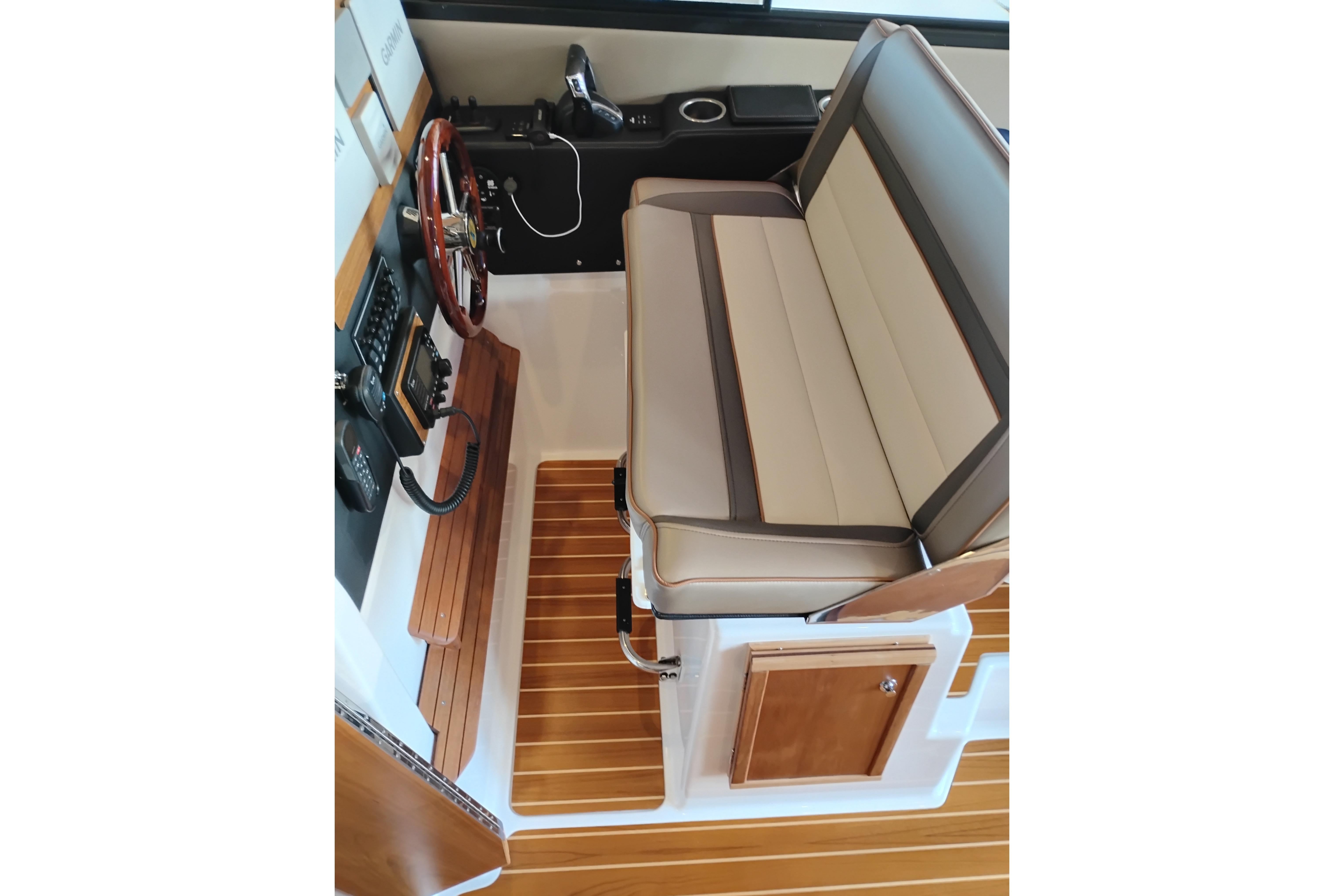 2022 Cutwater C-32 Coupe helm with leather seating and wooden steering wheel.