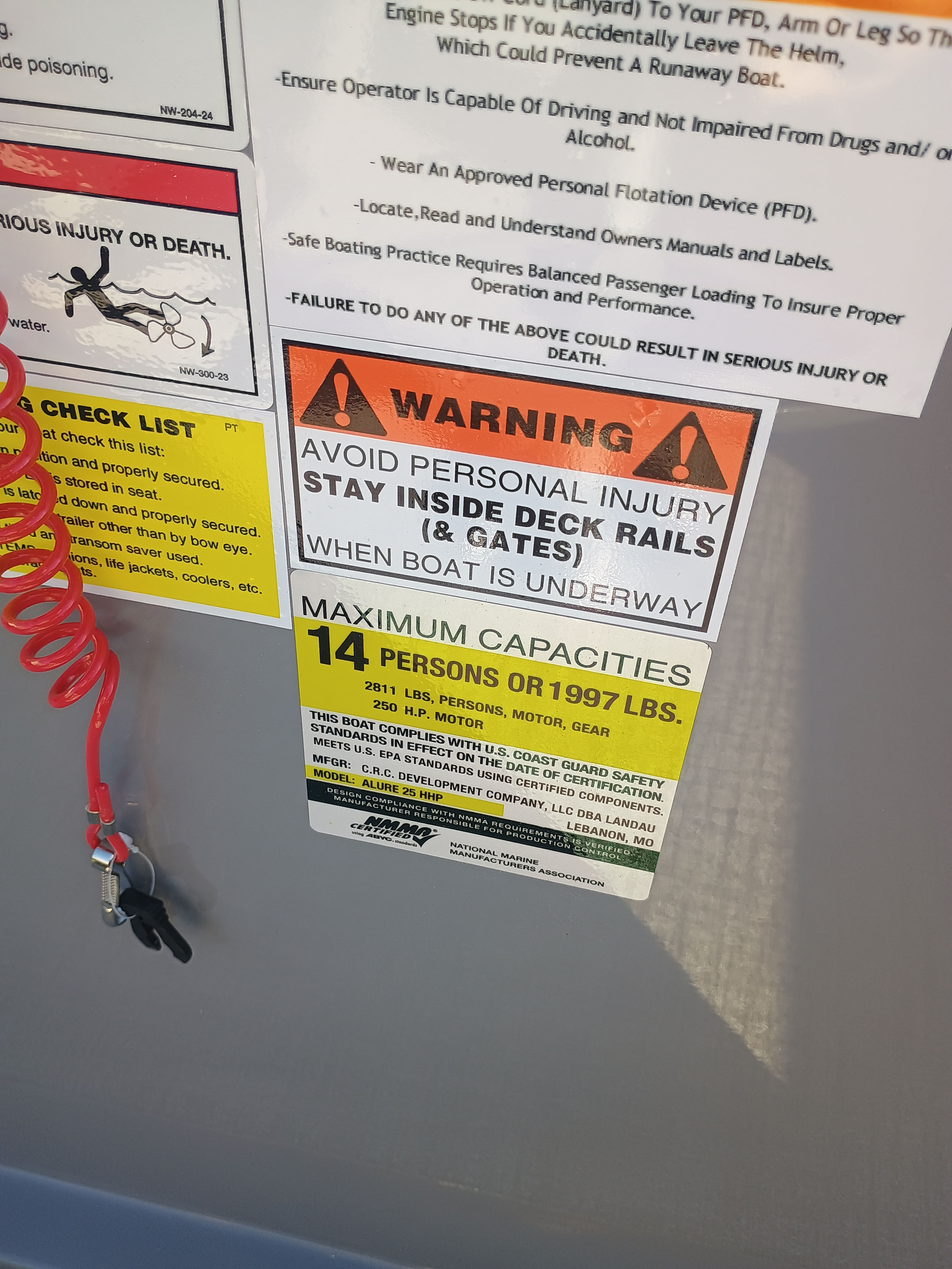 Warning sign on a Landau Alure 25CC boat, capacity 14 persons.