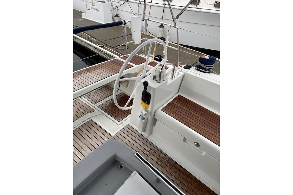 2018 Beneteau Oceanis 45 yacht cockpit with wooden deck and steering wheel.