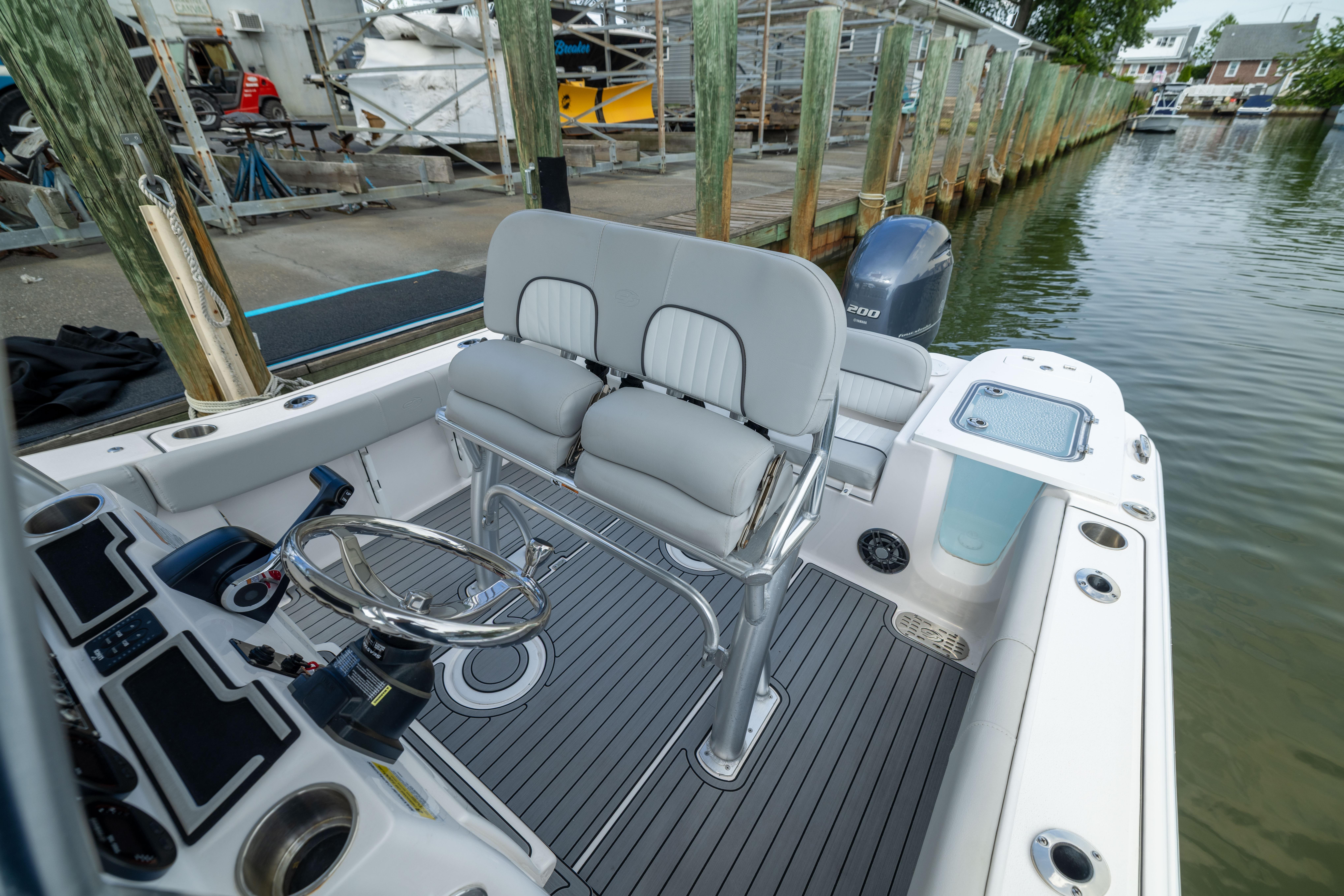2023 Sea Fox 228 Commander boat interior with helm, seating, and water view.