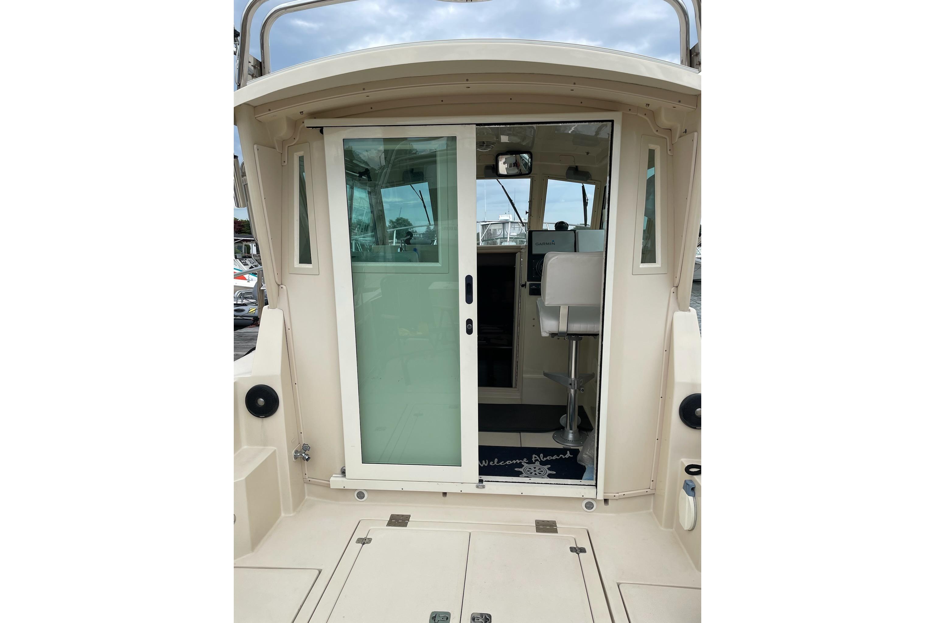 2003 Albin 28 Tournament Express boat with sliding glass door and interior view.