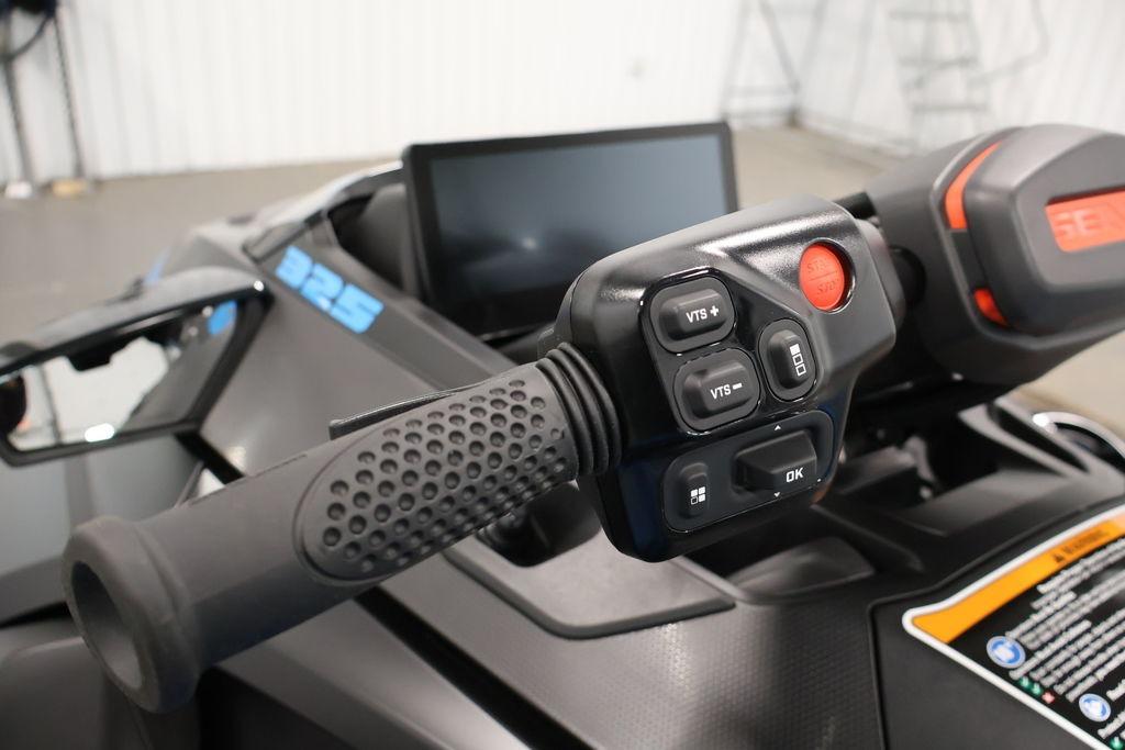2026 Sea-Doo RXT-X 325 handlebar controls with digital display in a showroom.