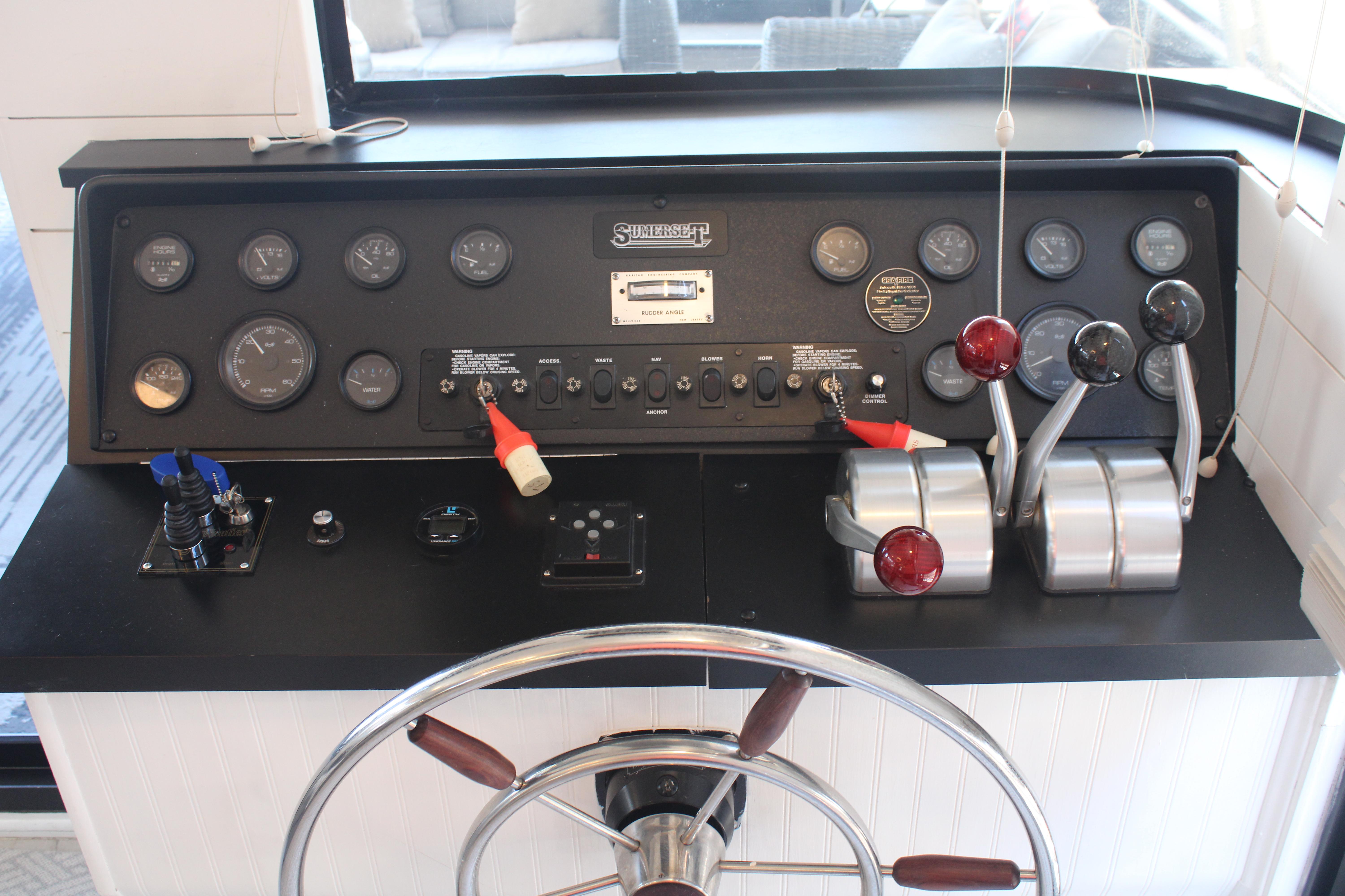 Control panel of a 1992 Sumerset 66 boat with gauges and steering wheel.