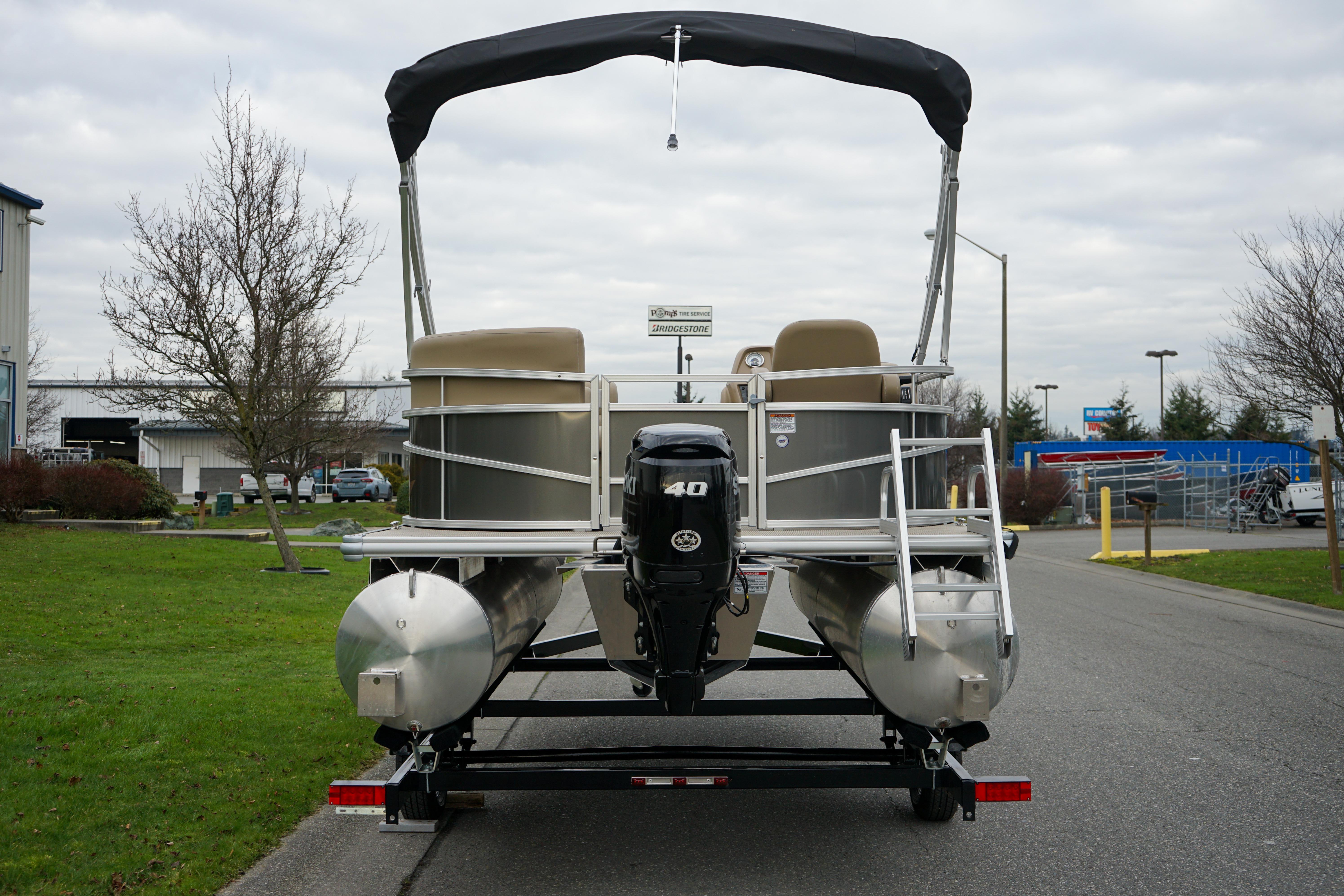 2025 Starcraft LX16R pontoon boat with canopy and outboard motor on trailer.