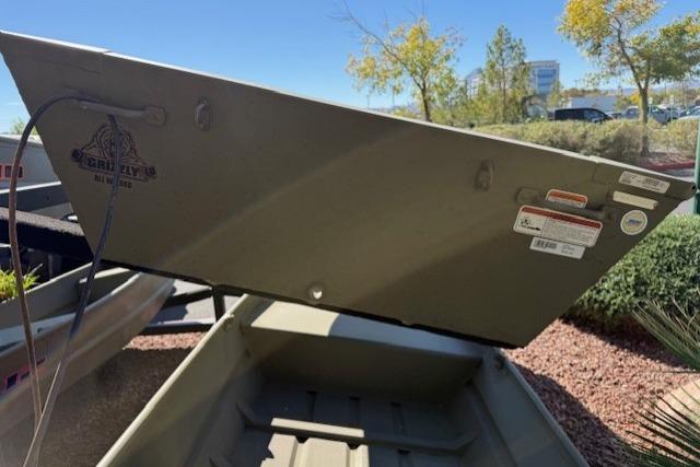 2026 Tracker Grizzly 12 Jon boat in outdoor setting, showcasing its sturdy design.