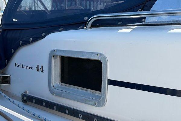 2011 Reliance 44 boat with window and blue canopy detail.