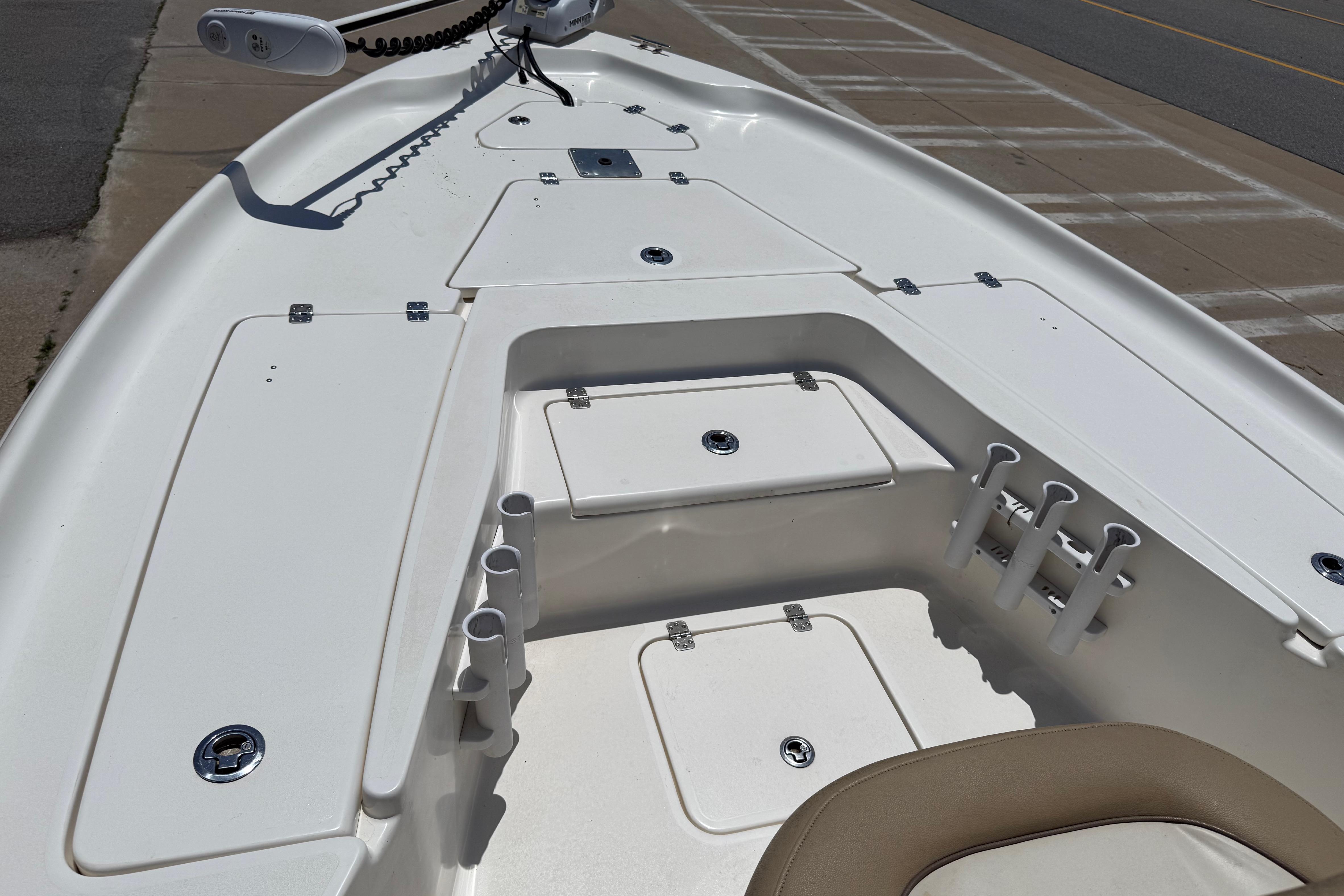 2019 Key West 230 Bay Reef boat deck with storage compartments and rod holders.