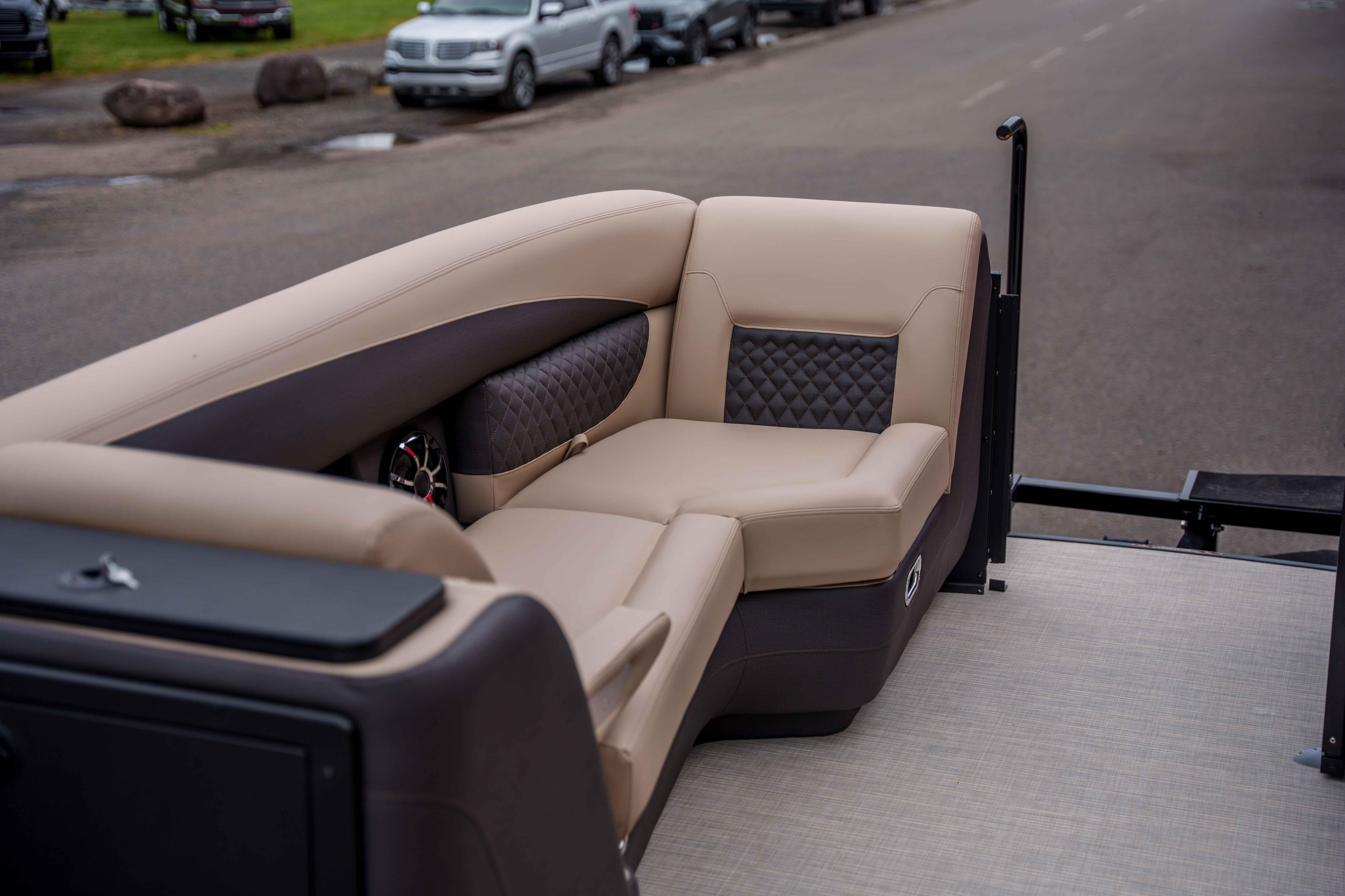 Luxurious seating on 2026 Harris Sunliner 230 pontoon boat, featuring elegant beige upholstery.