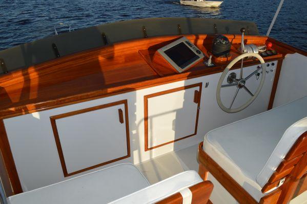 1990 Stanley 36' Downeast Fly Bridge Cruise interior with wooden helm and seating.