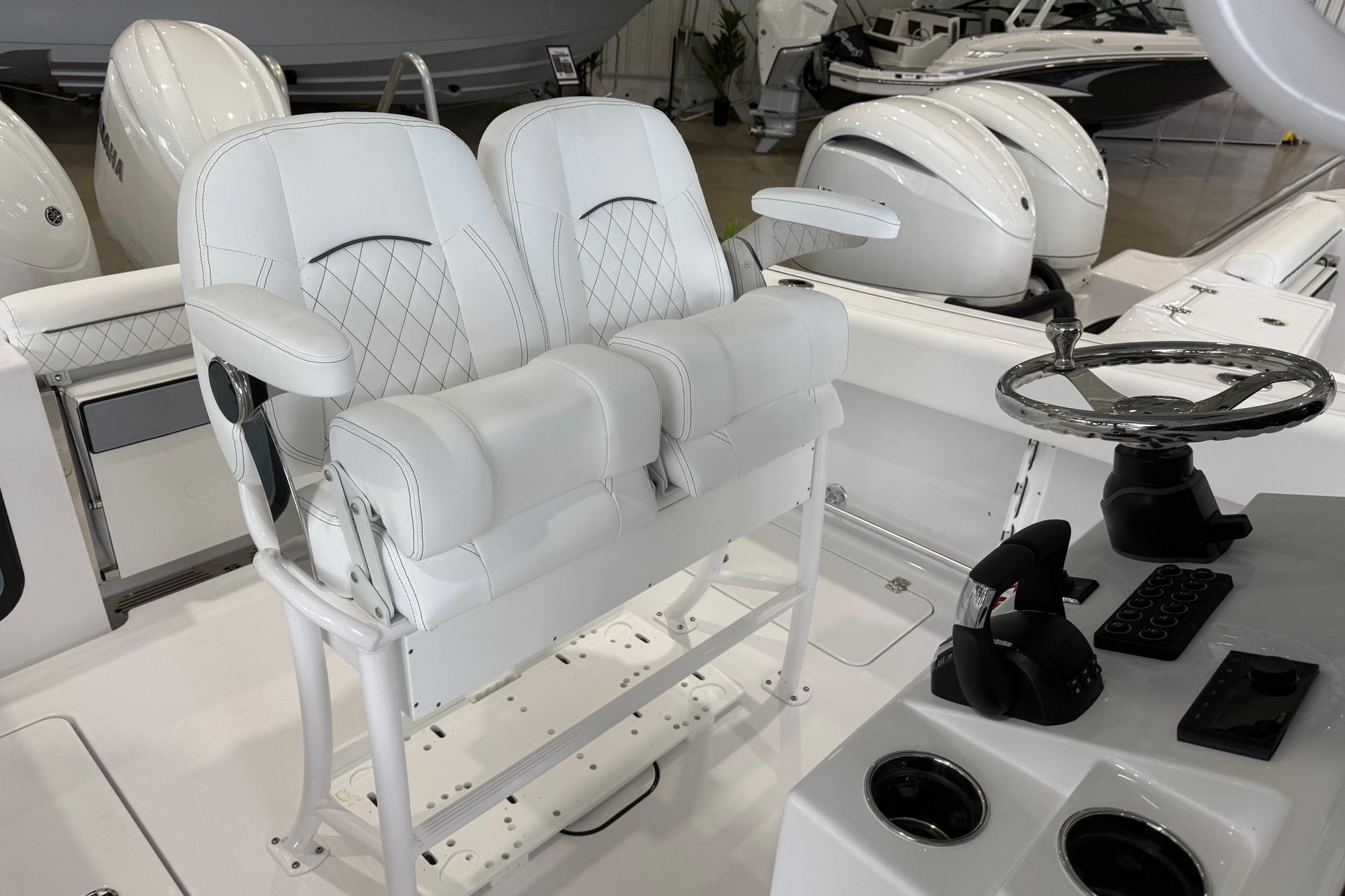 2026 Sportsman Open 252 Center Console boat interior with dual helm seats and steering wheel.