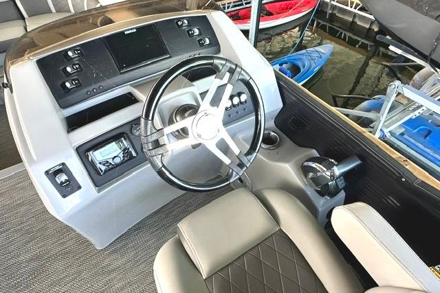2021 Bennington L Bowrider 25 Quad Bench dashboard with steering wheel and control panel.