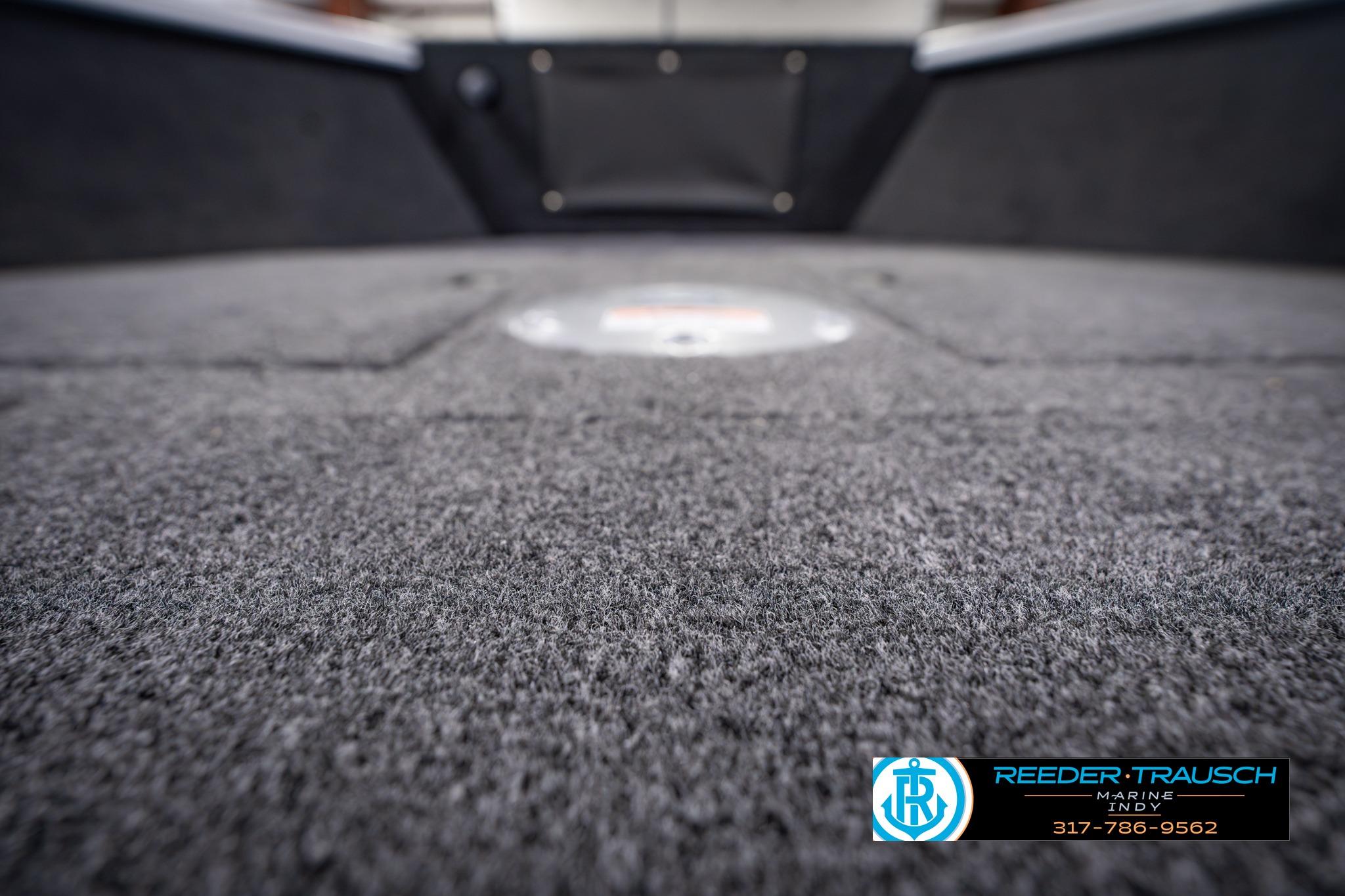 Carpeted deck of 2026 Lund 1650 Rebel XL SS boat, close-up view.