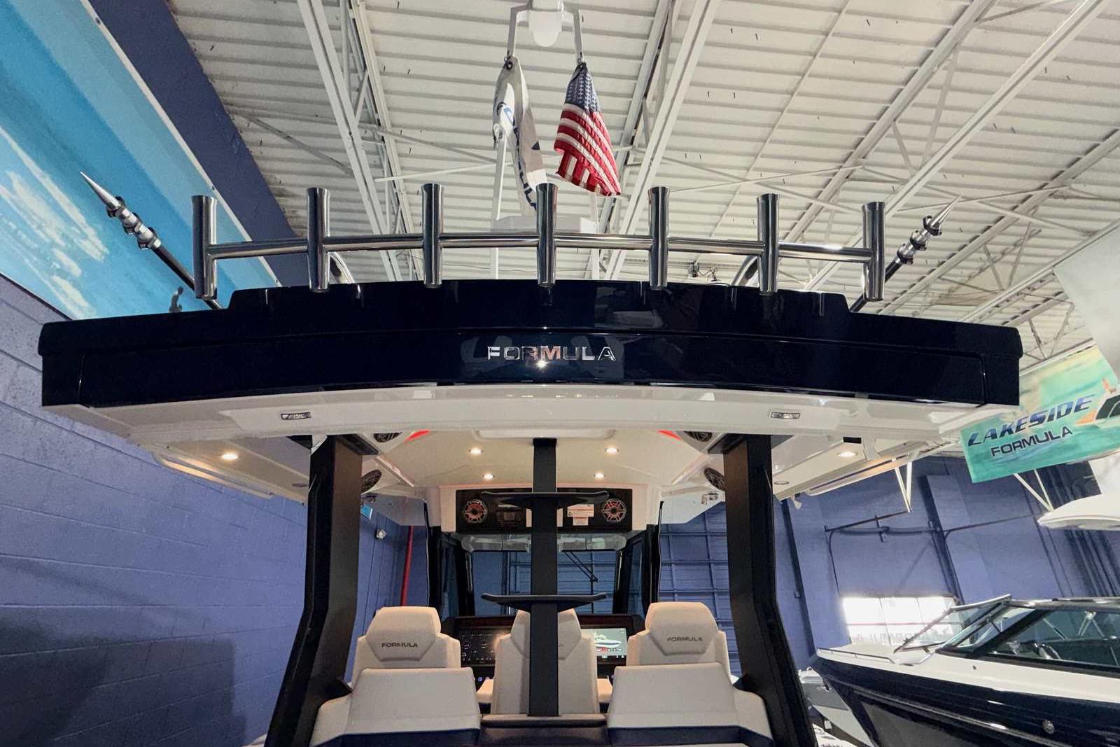 2025 Formula 387 Center Console Fish boat interior with rod holders and American flag.