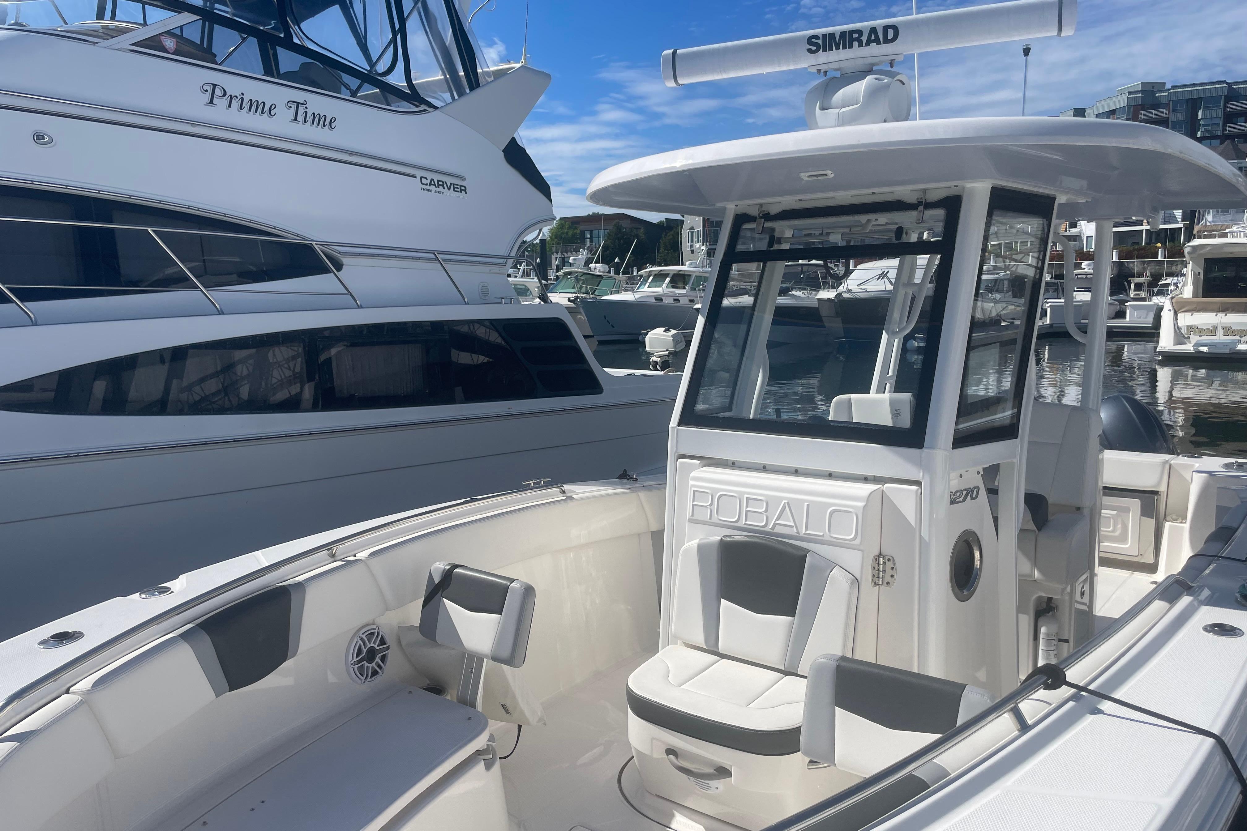 2023 Robalo R270 Center Console boat docked at marina, featuring sleek design and modern equipment.