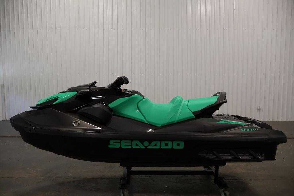 2026 Sea-Doo GTI SE 130 jet ski in black and teal, displayed indoors.