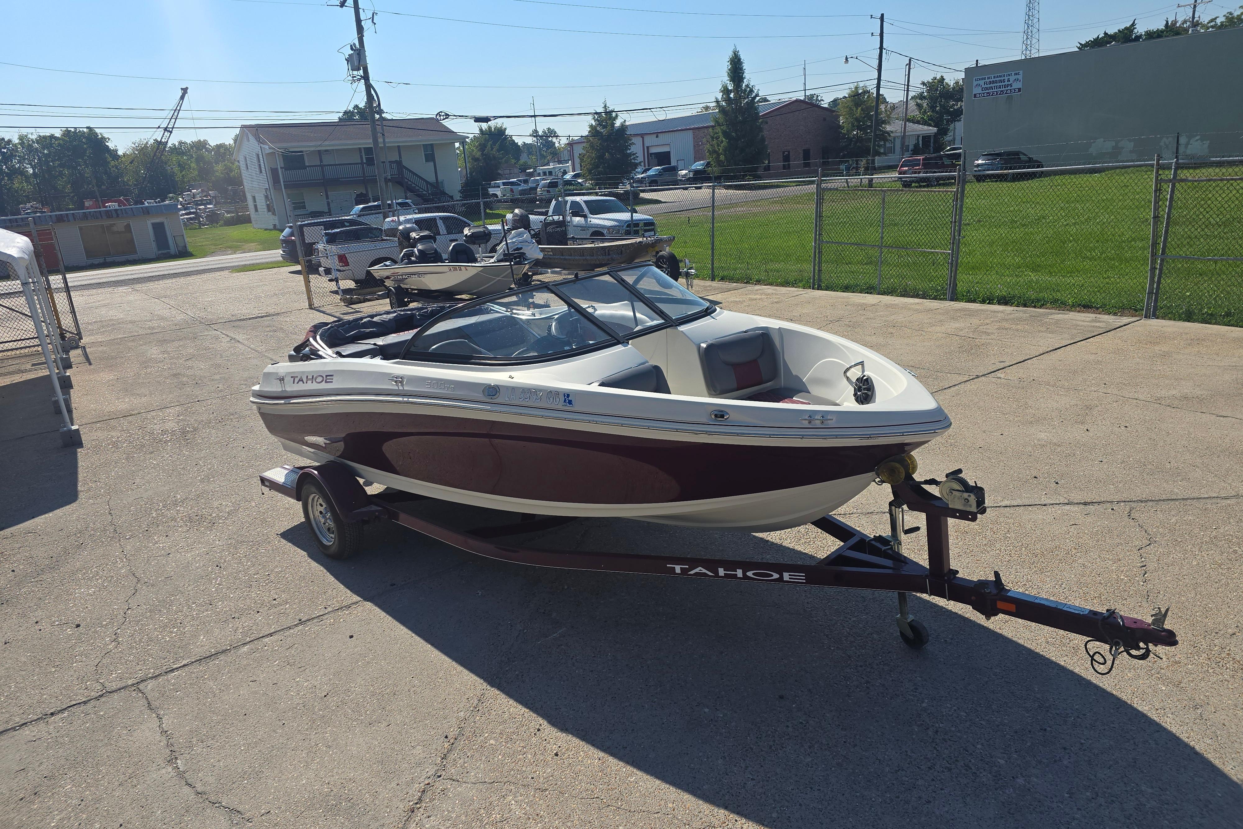 2016 Tahoe 500 TS boat on trailer in parking lot, sunny day.
