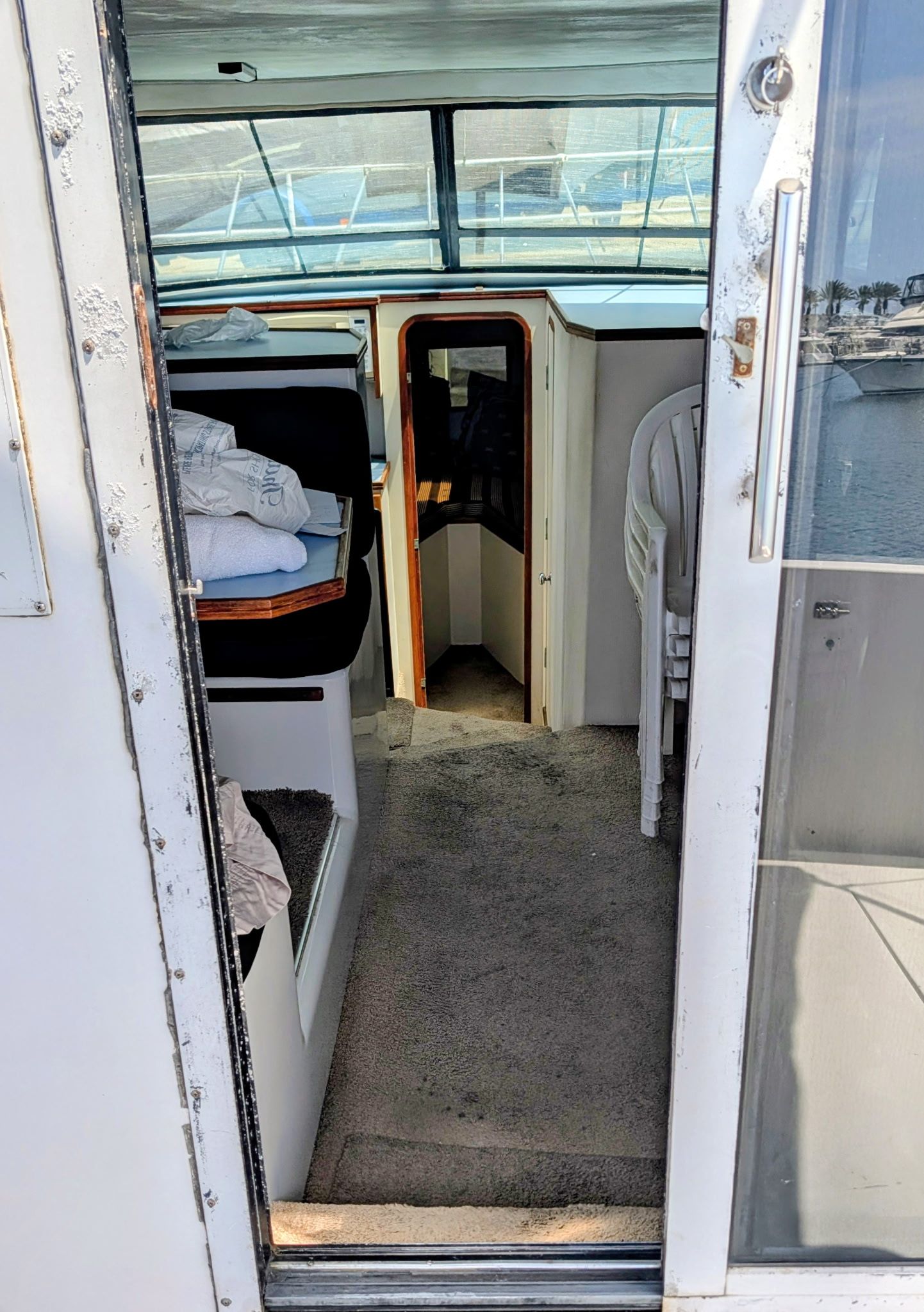 View into the cabin of a 1987 Chris-Craft 320 Amerosport Express with carpeted floor and seating area.