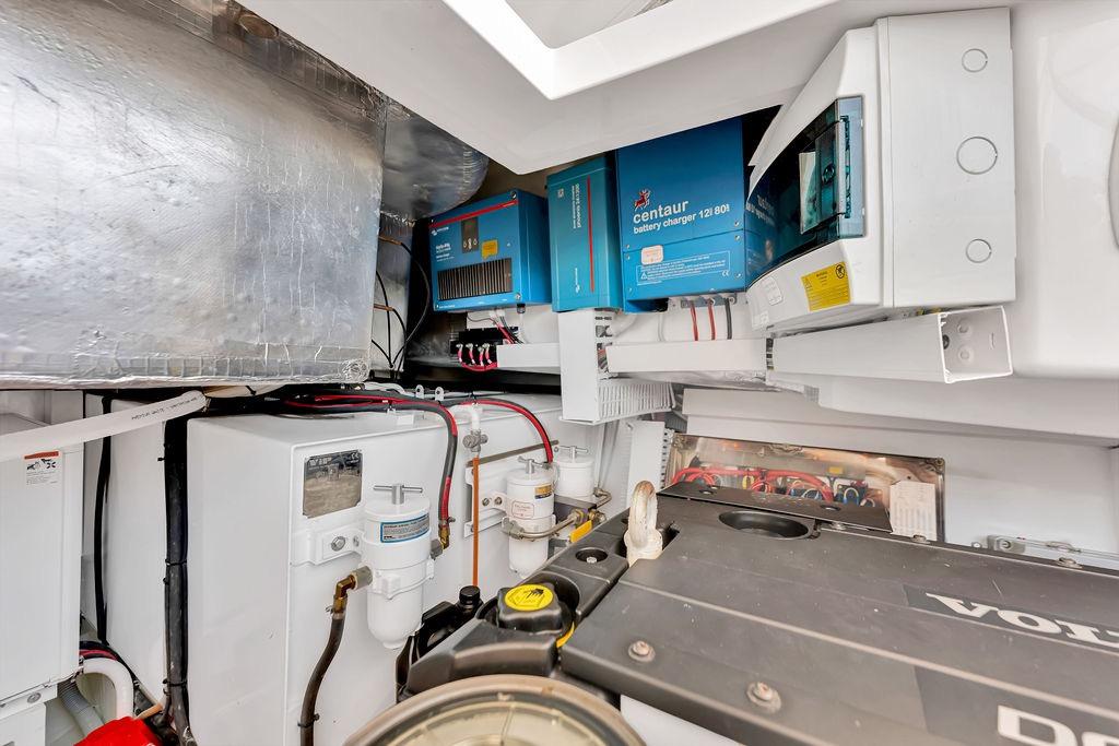 Engine room of 2021 Bluegame BG 42 yacht with battery charger and equipment.