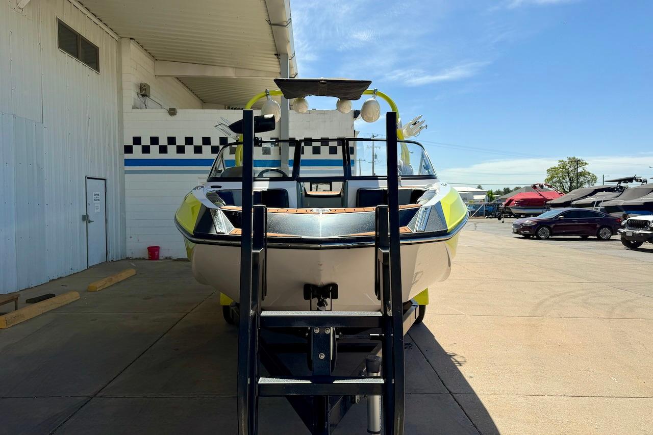 2014 Nautique Super Air Nautique G21 boat on trailer at a marina under clear skies.