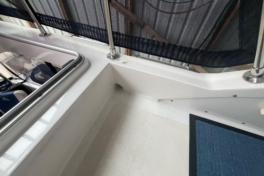 1976 Uniflite 32 Sport Sedan boat deck with railing and storage compartment.