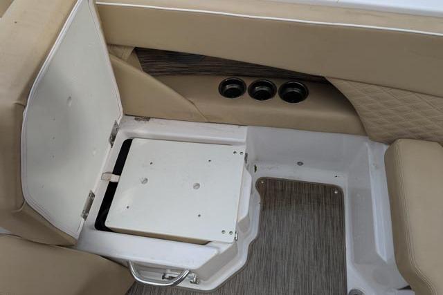 2017 Scarab 255 Platinum SE boat interior with open storage compartment and beige seating.