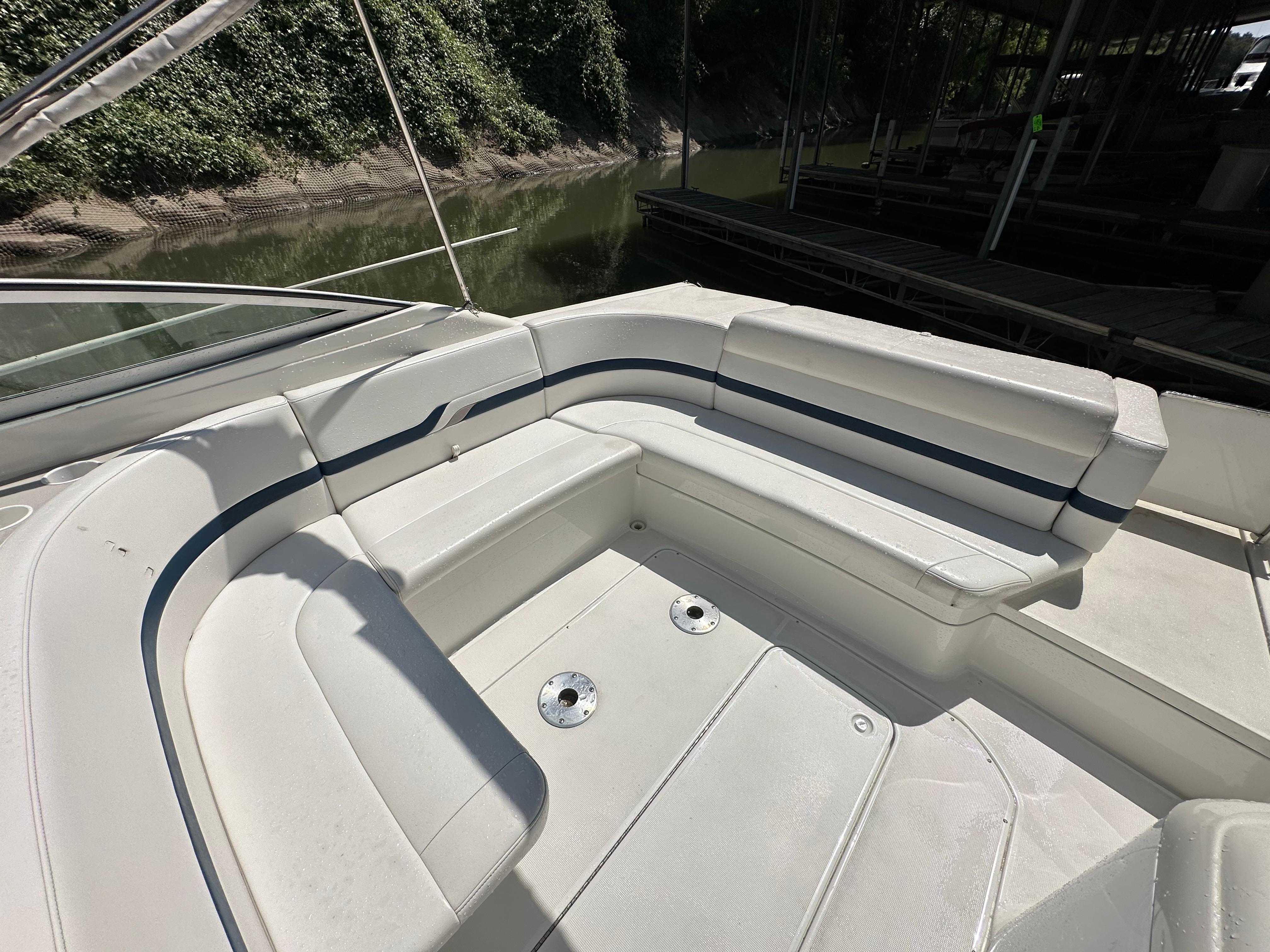 2000 Formula 330 SS boat with spacious white seating area by the water.