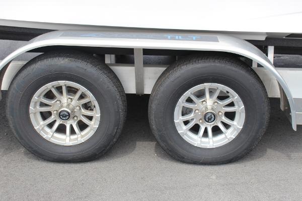 2023 Scarab 255 Open ID trailer wheels on pavement.