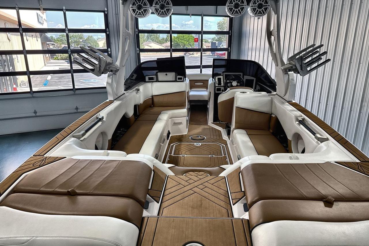 Luxurious interior of a 2020 Supra SE boat with brown and white seating.