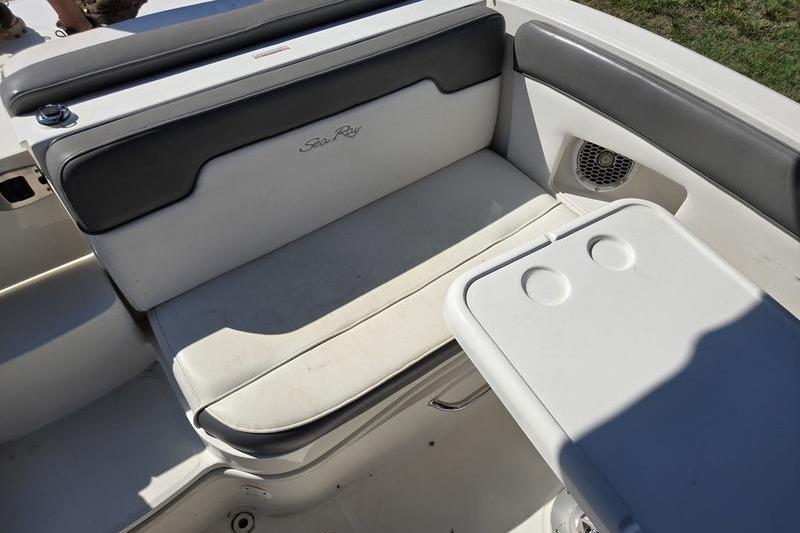 2011 Sea Ray 300 Sundeck interior seating with table and speaker.