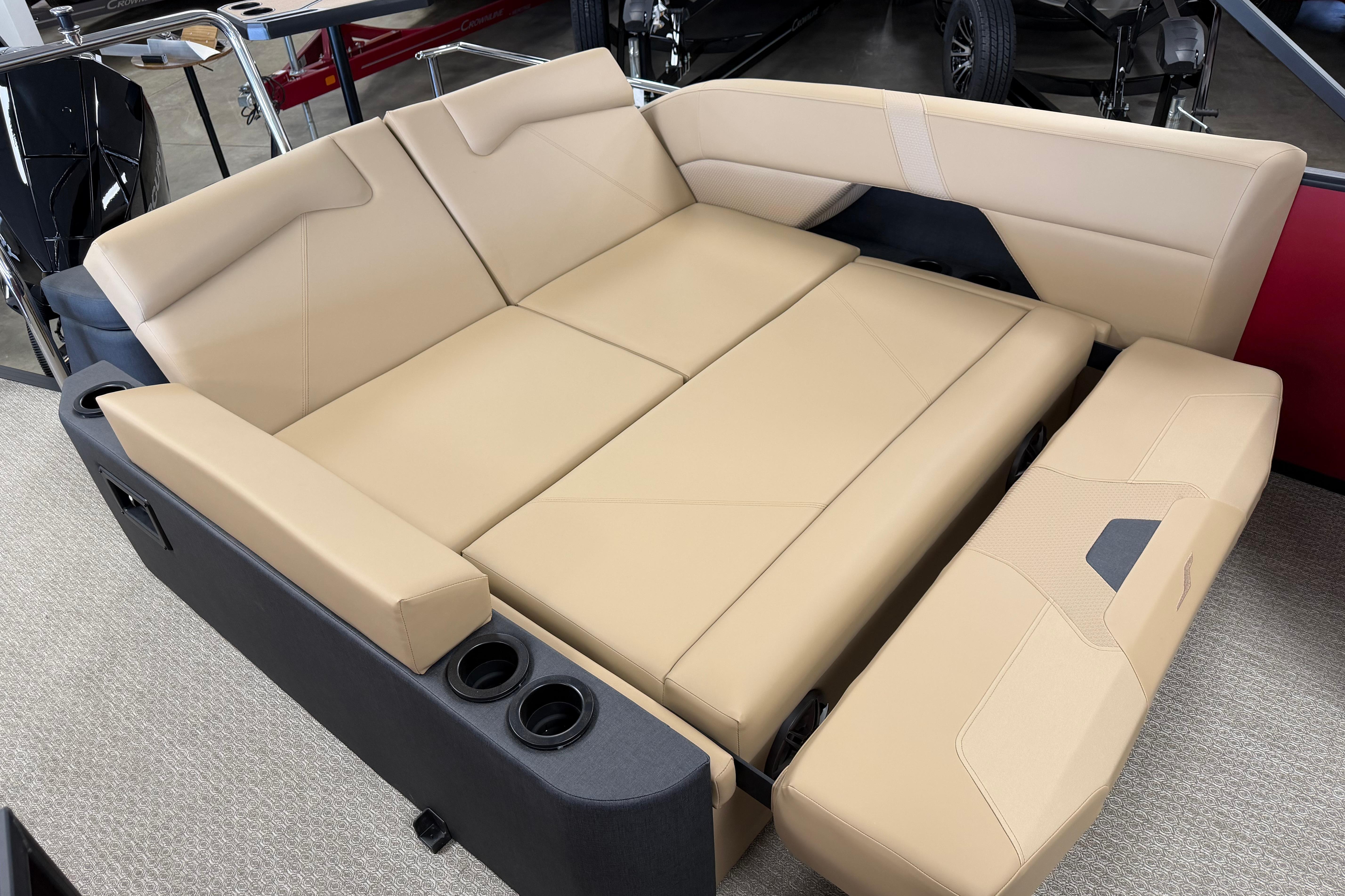 Luxurious beige seating in 2026 Evotti 523CS boat, featuring cup holders and modern design.