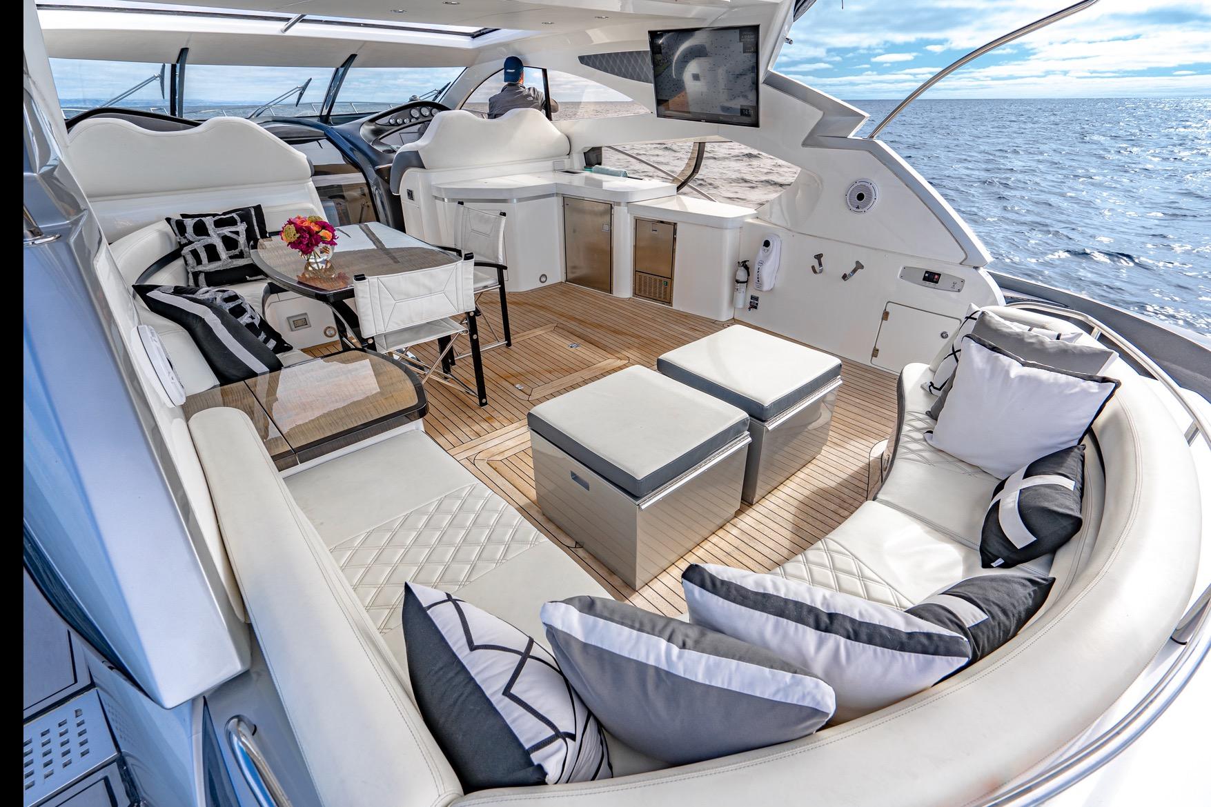 Luxurious Sunseeker Predator 68 yacht interior, 2021 model, featuring elegant seating and ocean view.