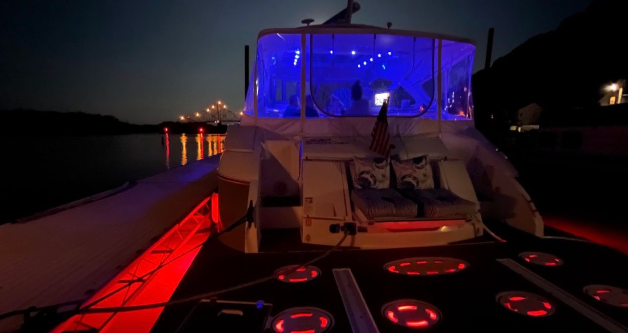 2009 Cruisers Yachts 520 Sports Coupe at night with glowing lights and cozy seating area.