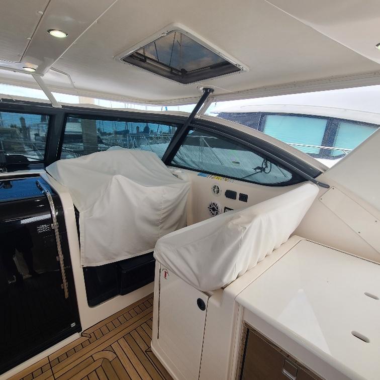 2003 Tiara Yachts 3800 Open interior with covered seating and helm, showcasing luxury design.
