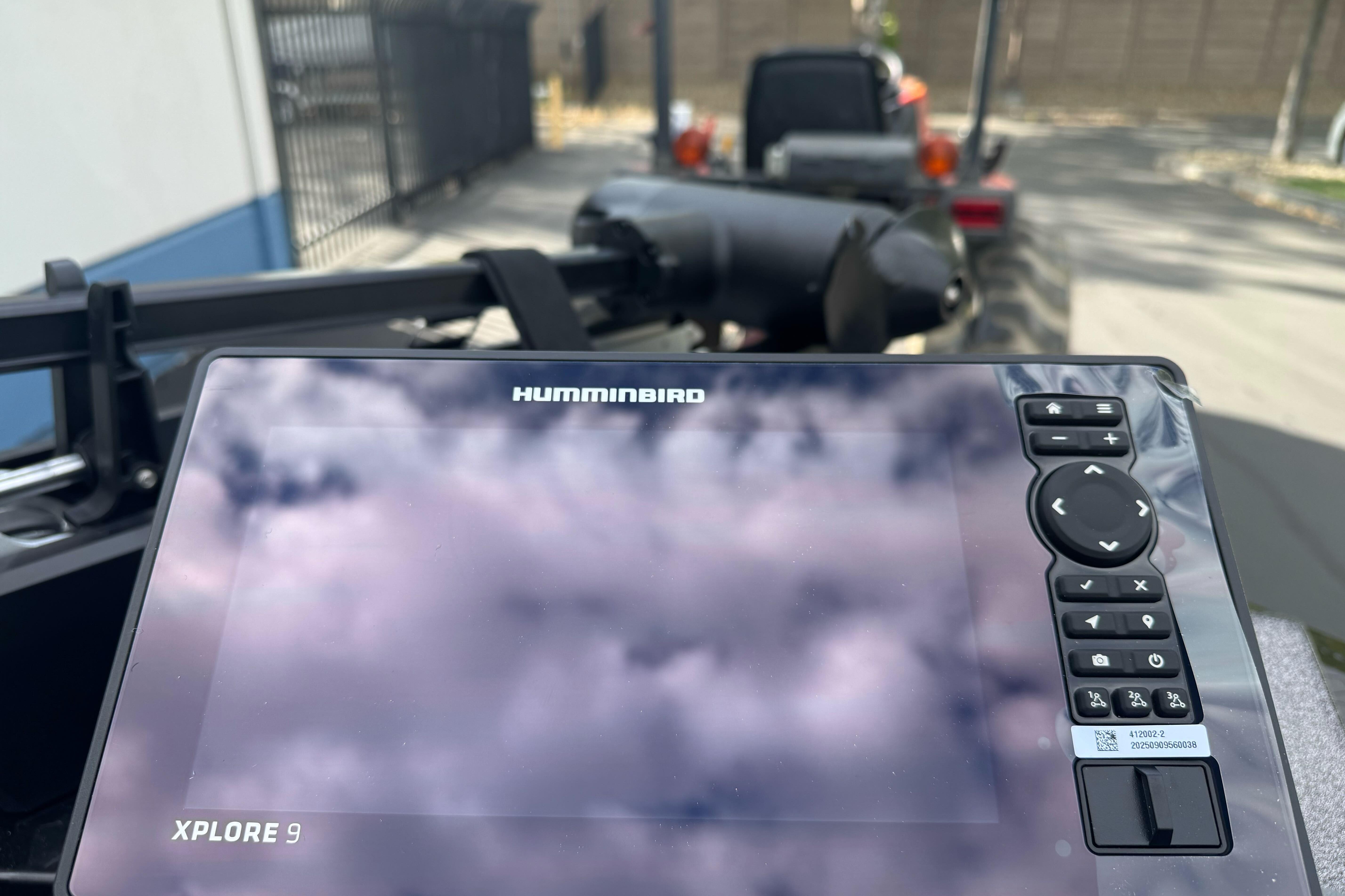 Humminbird Xplore 9 display on Ranger ALPHA 208, 2026 model, reflecting cloudy sky.