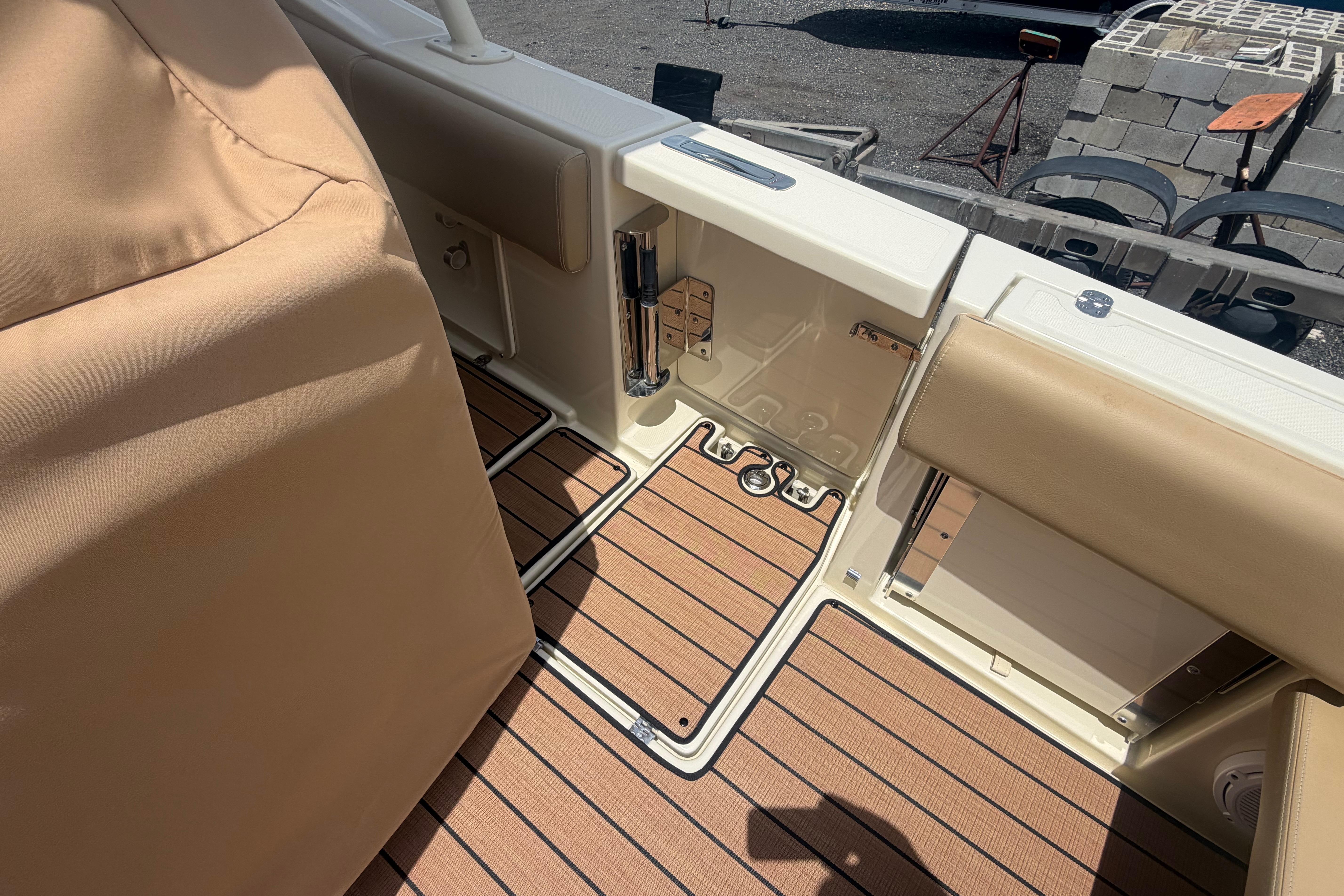 2017 Chris-Craft Catalina 34 boat interior with tan upholstery and wood-patterned flooring.