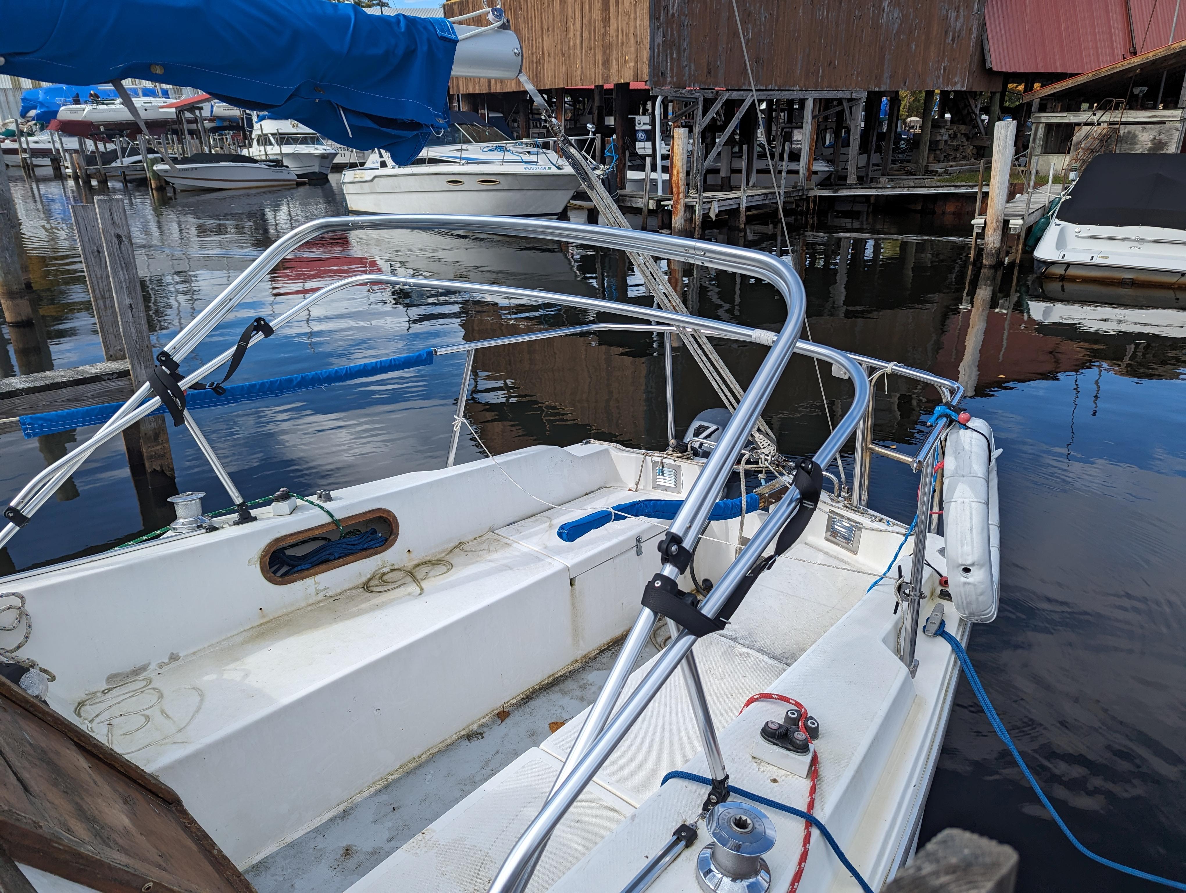 1987 Catalina 25 sailboat docked at a marina, showing the cockpit and rigging.